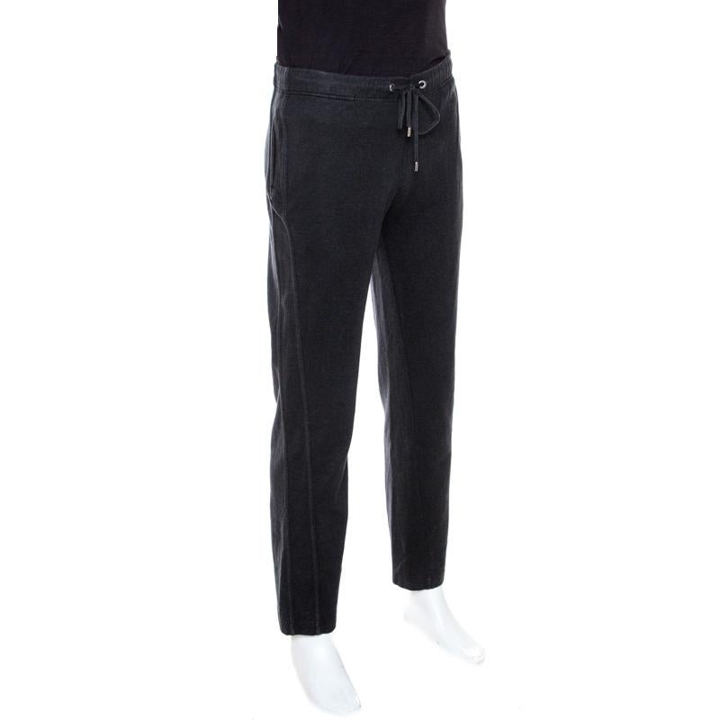 Now lounge around in comfort in these sweatpants from Louis Vuitton. The dark grey pants are made of a cotton blend and feature a simple design. They flaunt straight legs and come with a drawstring waist and pockets.

