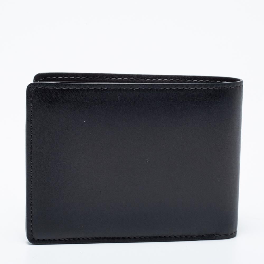 This wallet from the House of Louis Vuitton will help you store your valuables securely. It is made from dark-grey leather on the exterior. This wallet opens to a leather-lined interior, which can store all your important cards and