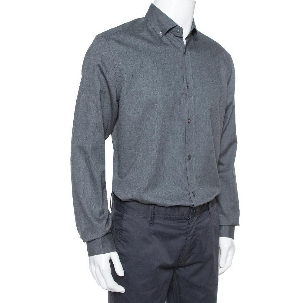 When it comes to subtle formal designs, Louis Vuitton leads the choice. This shirt features an understated dark grey shade with long cuffed sleeves, a simple collar and a textured finish. Cut from cotton, wear this out with smart-fitting trousers in