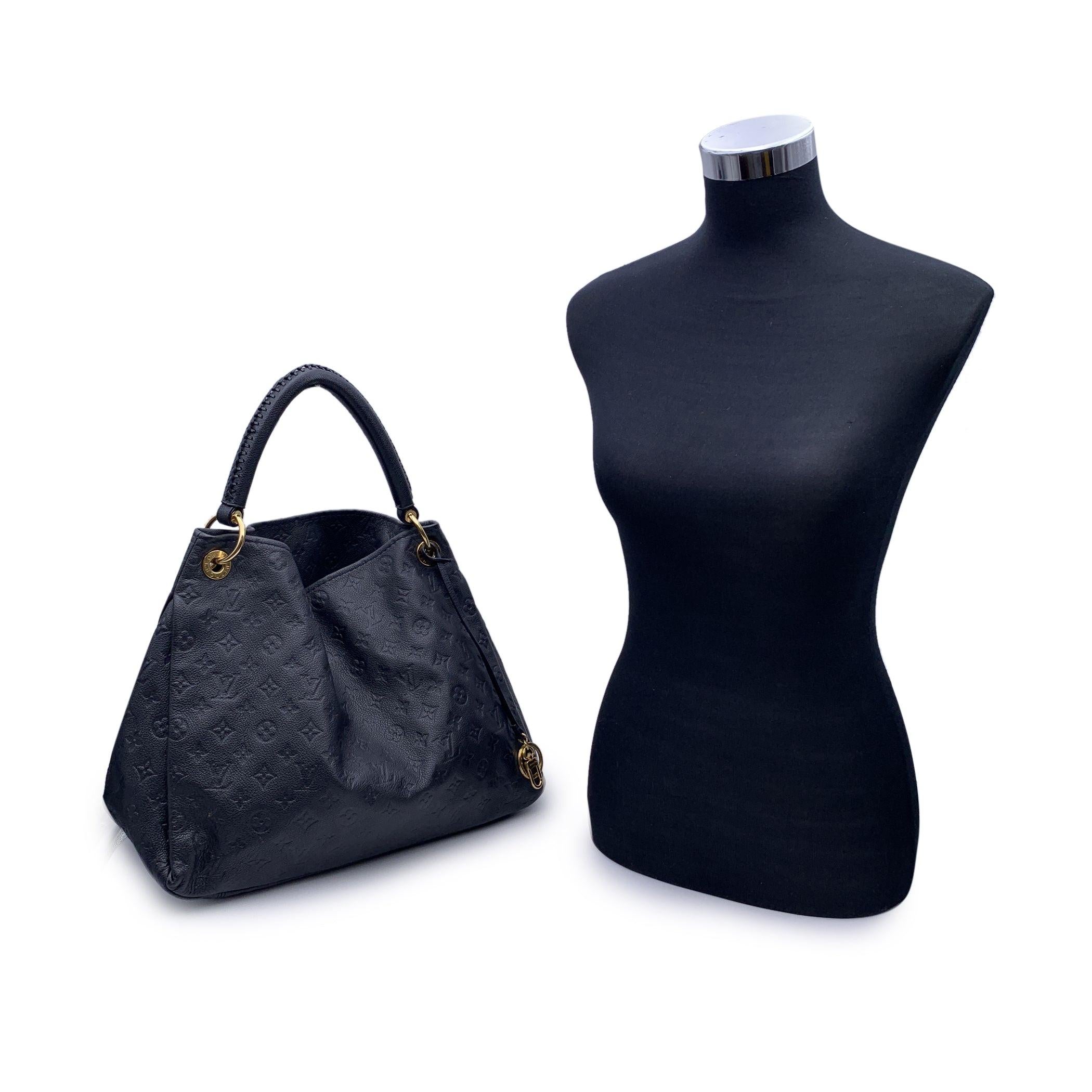Elegant Louis Vuitton navy blue Monogram Empreinte 'Artsy MM' Tote Bag. It features open top, fabric lining and removable gold metal key ring and hook . Canvas lining. 1 side zip pocket and 2 side open pockets inside. 'Louis Vuitton Paris - Made in