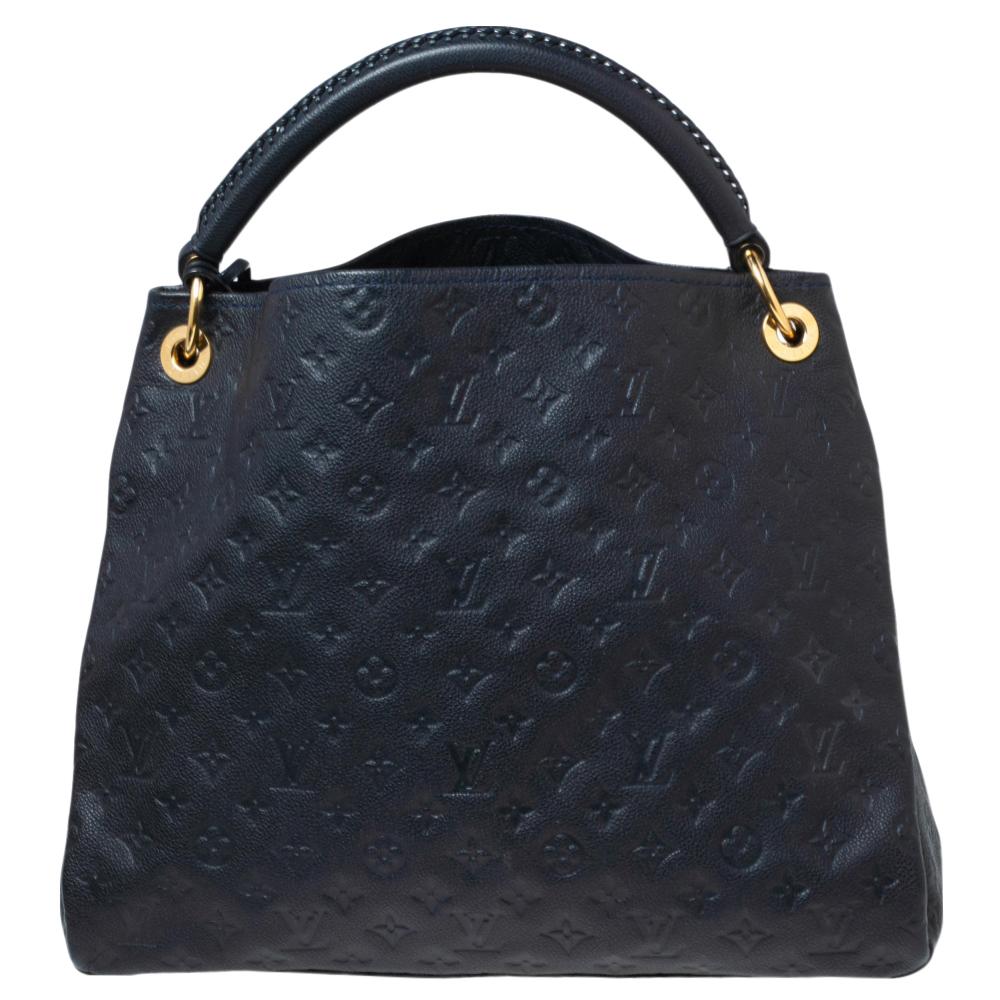 Flaunt this Louis Vuitton Artsy bag like a fashionista! Crafted from their signature Monogram Empreinte leather, this bag features an open top that reveals a canvas-lined interior, spacious enough to carry all your essentials. The bag is completed