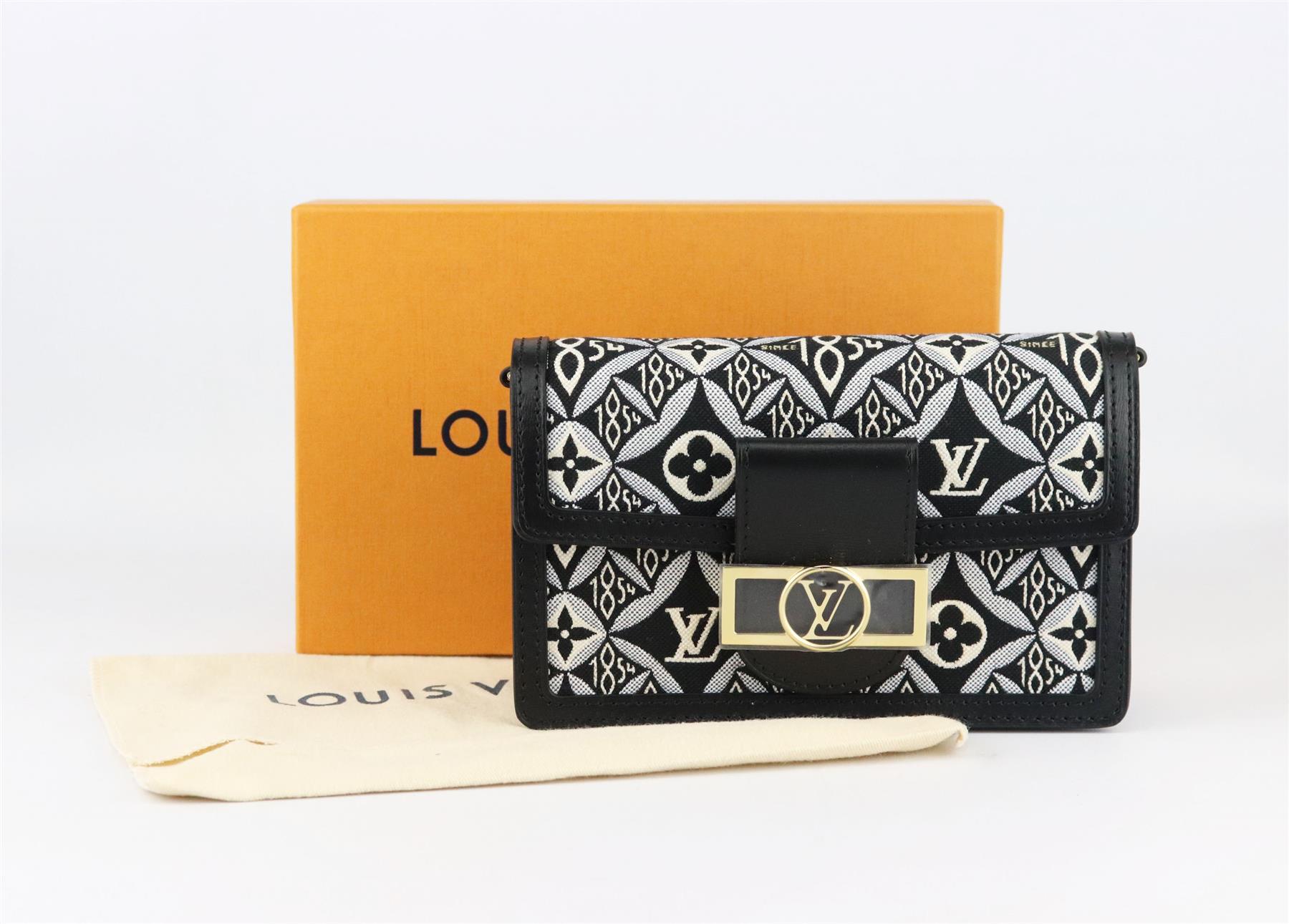 Louis Vuitton ‘Dauphine’ bag has the brand’s signature ‘Since 1854’ canvas textile fabric on a wallet on chain with a slim detachable gold-tone chain, so you can carry it as a shoulder bag, made in Italy from black smooth leather trim, it's finished