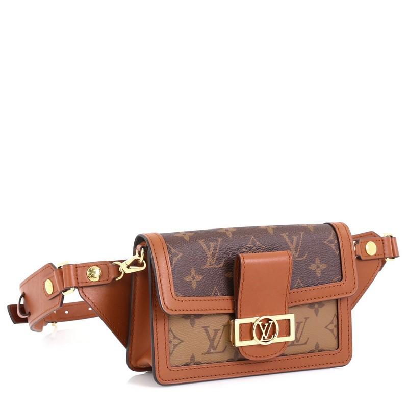This Louis Vuitton Dauphine Bumbag Reverse Monogram Canvas, crafted from brown reverse monogram coated canvas, features an adjustable leather strap, leather trim, LV logo on flap, and silver-tone hardware. Its magnetic snap closure opens to a black
