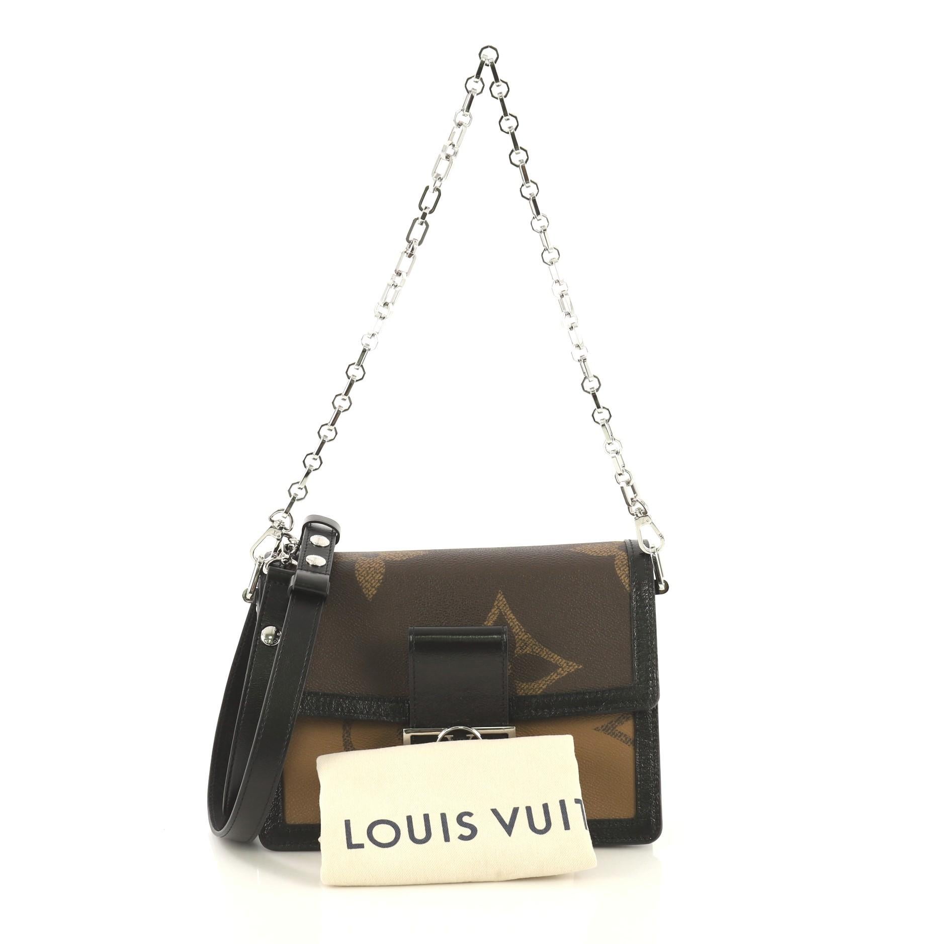 This Louis Vuitton Dauphine Shoulder Bag Limited Edition Reverse Monogram Giant MM, crafted from brown reverse monogram coated canvas, features a flat leather strap, chain strap, leather trim, LV logo on flap, and silver-tone hardware. Its magnetic