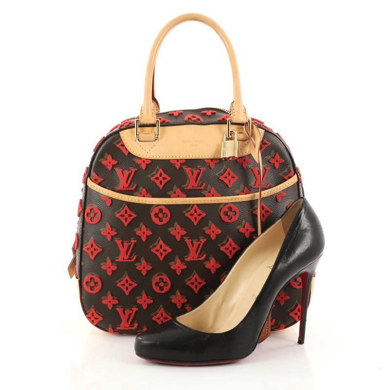 This authentic Louis Vuitton Deauville Cube Bag Limited Edition Monogram Canvas Tuffetage is a modern and unique twist on a timeless silhouette. Constructed of classic Louis Vuitton brown monogram coated canvas with red tufting and natural leather