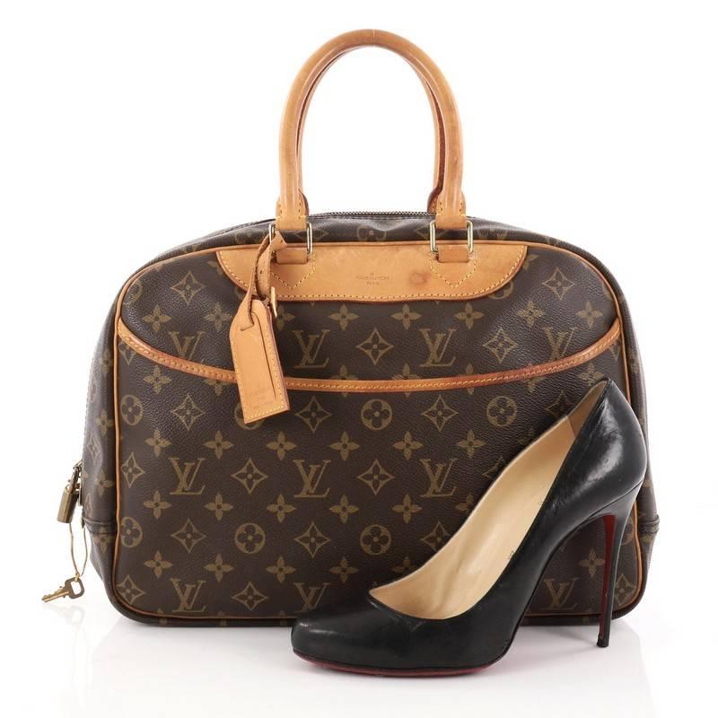 This authentic Louis Vuitton Deauville Handbag Monogram Canvas was popularly known as a vanity case yet has become an everyday staple. Constructed from brown monogram coated canvas, this bag features dual rolled vachetta leather handles and trims,