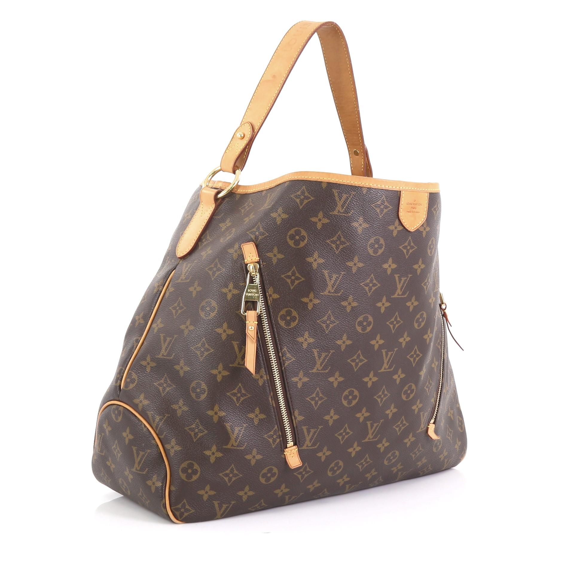 This Louis Vuitton Delightful Handbag Monogram Canvas GM, crafted in brown monogram coated canvas, features a flat leather loop handle, two exterior zip pockets, and gold-tone hardware. Its hook closure opens to a light brown fabric interior with
