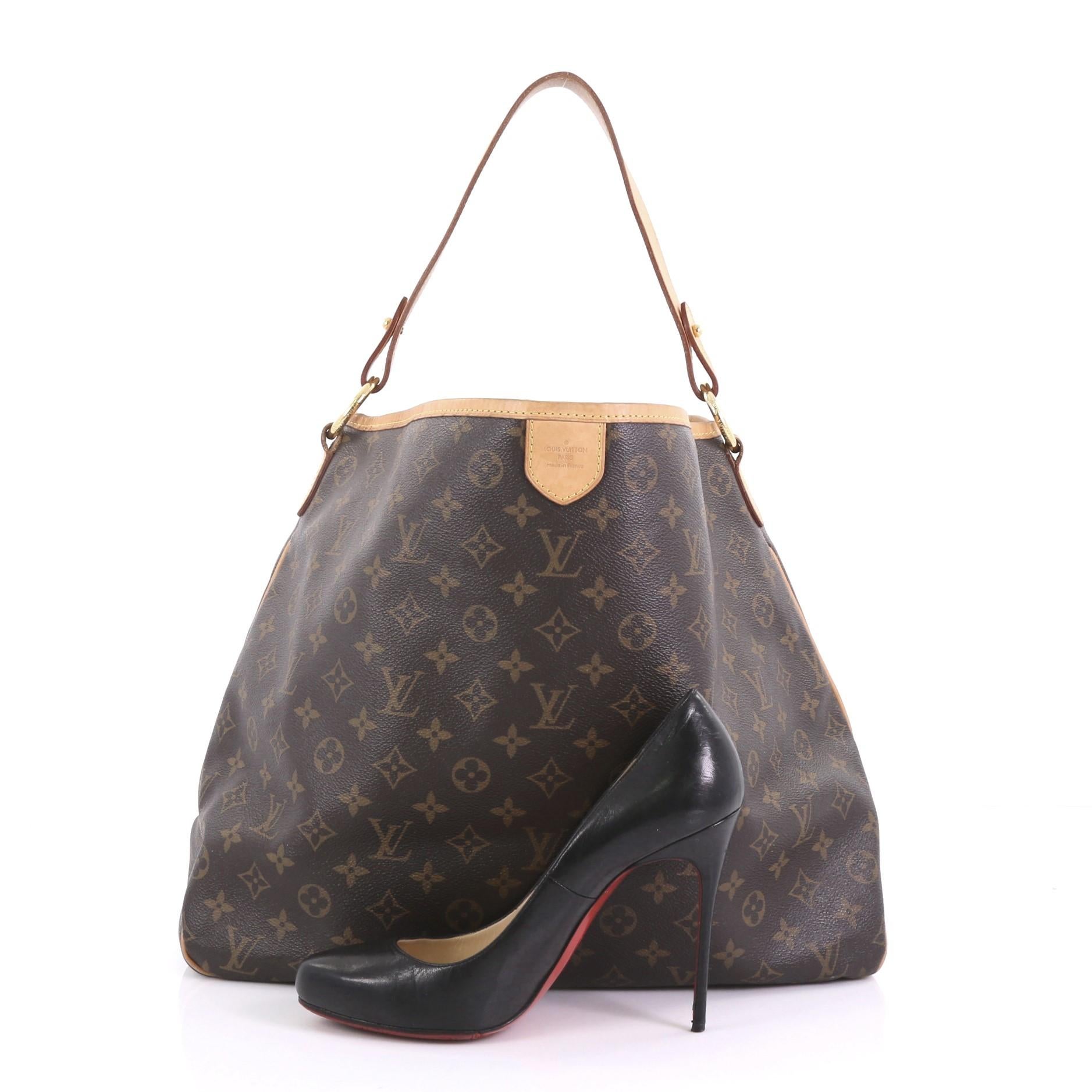 This Louis Vuitton Delightful Handbag Monogram Canvas MM, crafted in brown monogram coated canvas, features a flat leather loop handle, cowhide leather trims, and gold-tone hardware. Its snap hook closure opens to a light brown fabric interior with