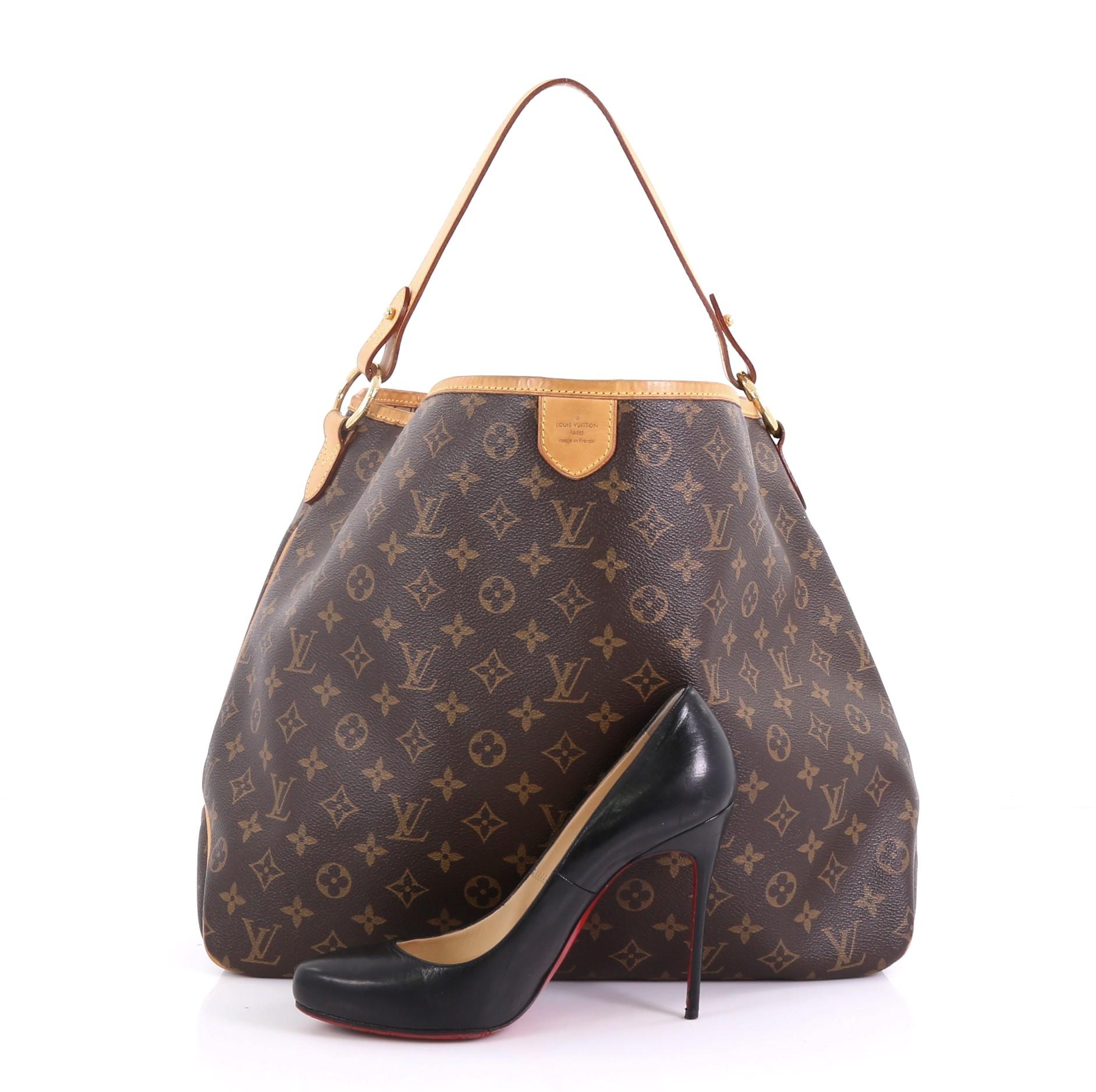 This Louis Vuitton Delightful Handbag Monogram Canvas MM, crafted in brown monogram coated canvas, features a flat leather loop handle, cowhide leather trim, and gold-tone hardware. Its snap hook closure opens to a brown fabric interior with side