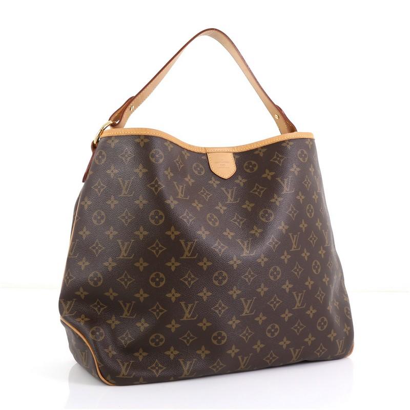 This Louis Vuitton Delightful Handbag Monogram Canvas MM, crafted in brown monogram coated canvas, features a flat leather loop handle, cowhide leather trim, and gold-tone hardware. Its snap hook closure opens to a brown fabric interior with side