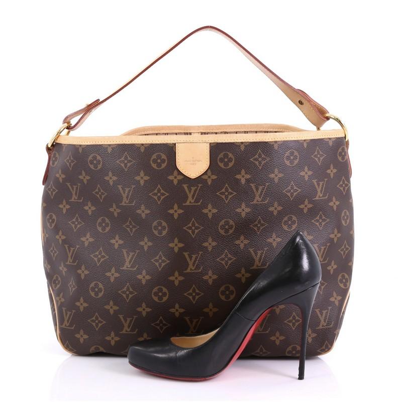 This Louis Vuitton Delightful Handbag Monogram Canvas PM, crafted in brown monogram coated canvas, features a flat leather loop handle, cowhide leather trim, and gold-tone hardware. Its snap hook closure opens to a brown fabric interior with side