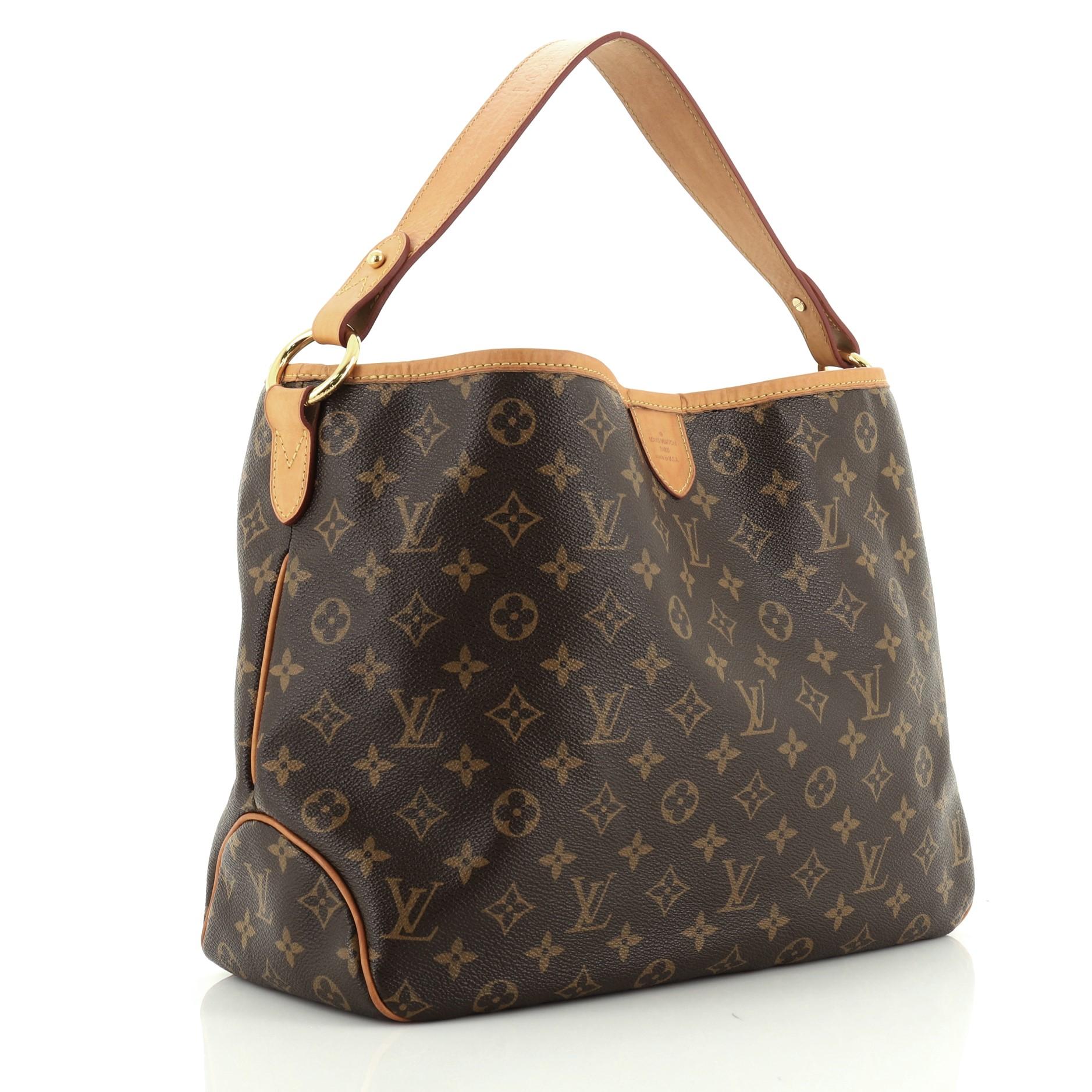 This Louis Vuitton Delightful Handbag Monogram Canvas PM, crafted in brown monogram coated canvas, features a flat leather loop handle, cowhide leather trim, and gold-tone hardware. Its hook closure opens to a neutral fabric interior with side zip