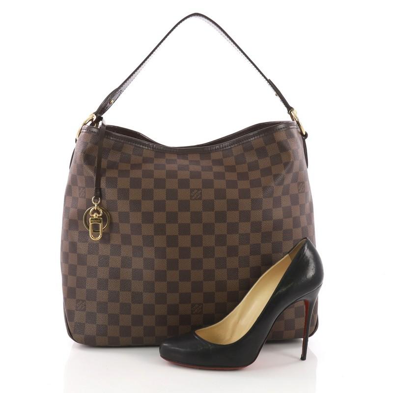 This Louis Vuitton Delightful NM Handbag Damier MM, crafted in damier ebene coated canvas, features flat leather handle and gold-tone hardware. Its hook closure opens to a red striped fabric interior with side zip pocket. Authenticity code reads: