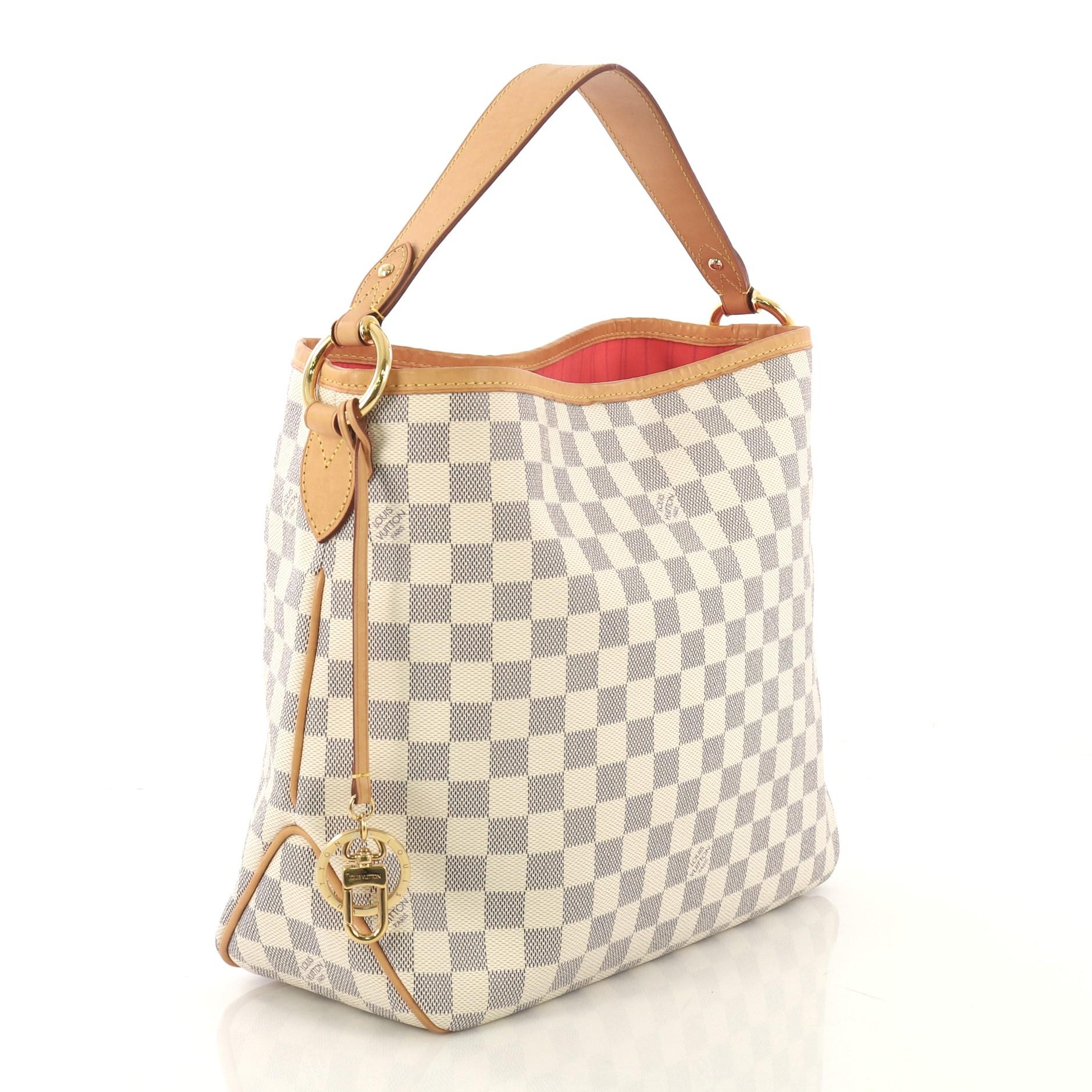 This Louis Vuitton Delightful NM Handbag Damier PM, crafted in damier azur coated canvas, features a flat leather handle and gold-tone hardware. Its hook closure opens to a pink fabric interior with side zip pocket. Authenticity code reads: M12175.