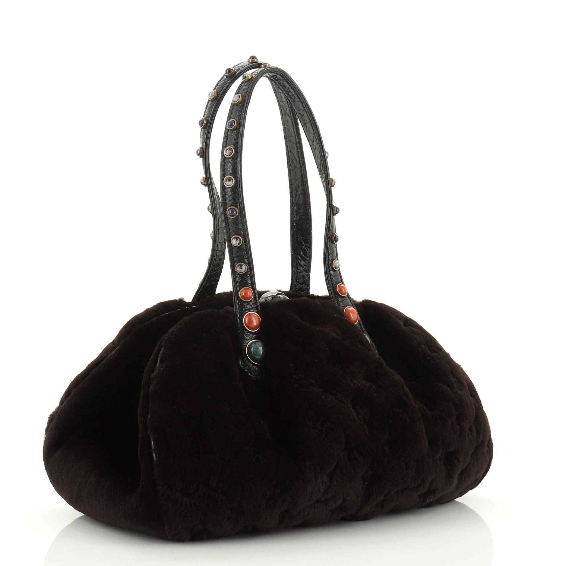 This Louis Vuitton Demi Lune Handbag Monogram Mink, crafted from brown monogram mink, features dual studded handles and aged gold-tone hardware. Its zip closure opens to a black satin interior. Authenticity code reads: RE0055 

Estimated Retail