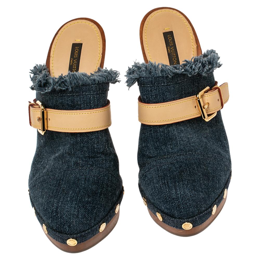 Comfort and style come together to form these fabulous Louis Vuitton mules. The blue clogs are crafted from denim and feature covered toes, buckled leather straps on the vamps, stud accents, and comfortable insoles. They are complete with platforms