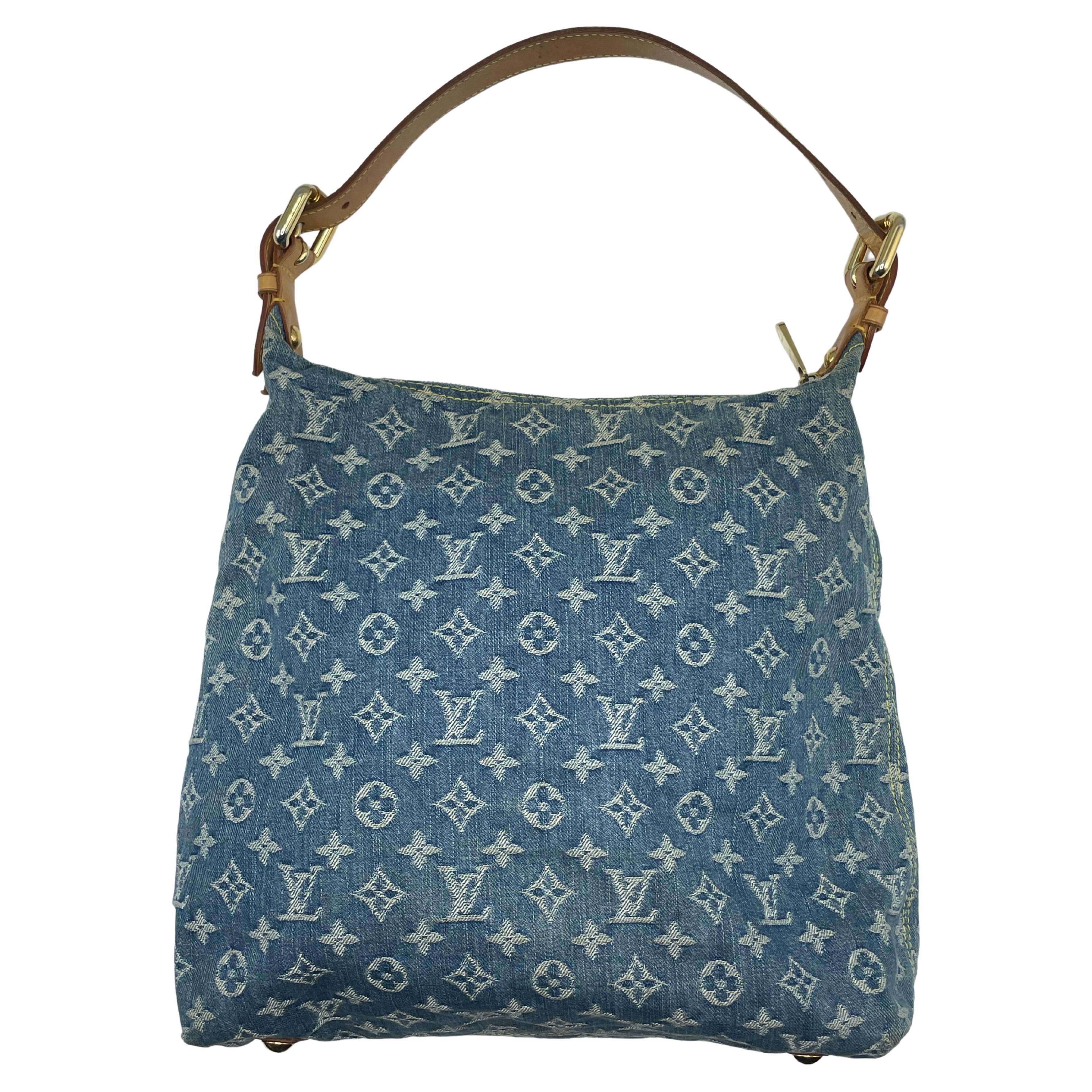 This blue LOUIS VUITTON Denim Baggy GM is genuine. This fashionable hobo is constructed of blue Louis Vuitton monogram denim. The shoulder bag has two front pockets with polished gold push locks, a huge pocket with a zipper, and an adjustable