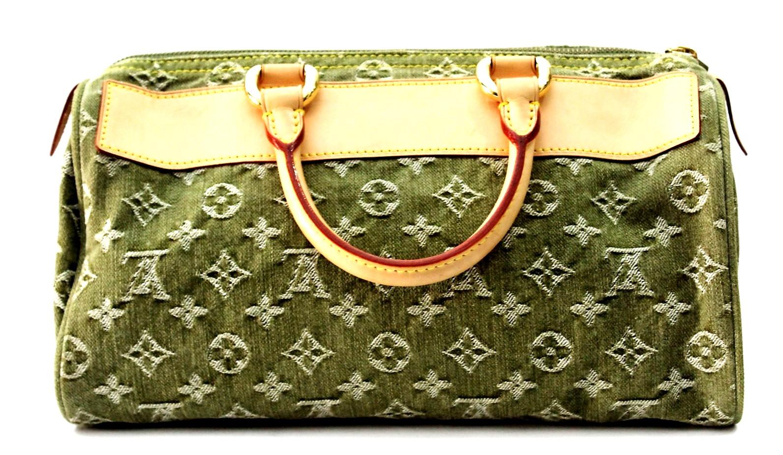 This chic Speedy tote is crafted of Louis Vuitton monogram denim in green. This bag features rolled leather top handles, a full length front zipper pocket, two exterior flap pockets, a zip top, and polished brass hardware. The top zipper opens to a