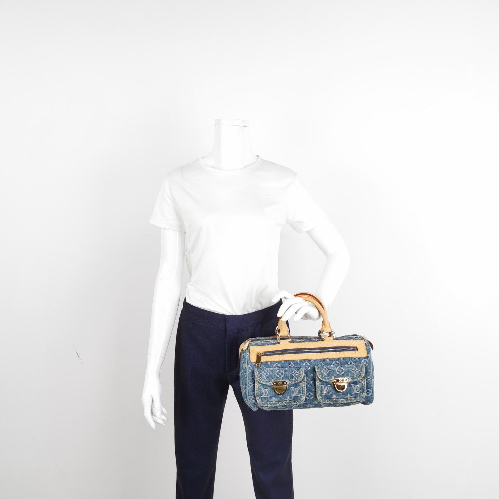 Light wash blue monogram denim Louis Vuitton Neo Speedy with brass hardware, tan vachetta leather trim, dual rolled top handles, three exterior pockets; one with zip closure, marigold Alcantara lining, single interior slit pocket and zip closure at