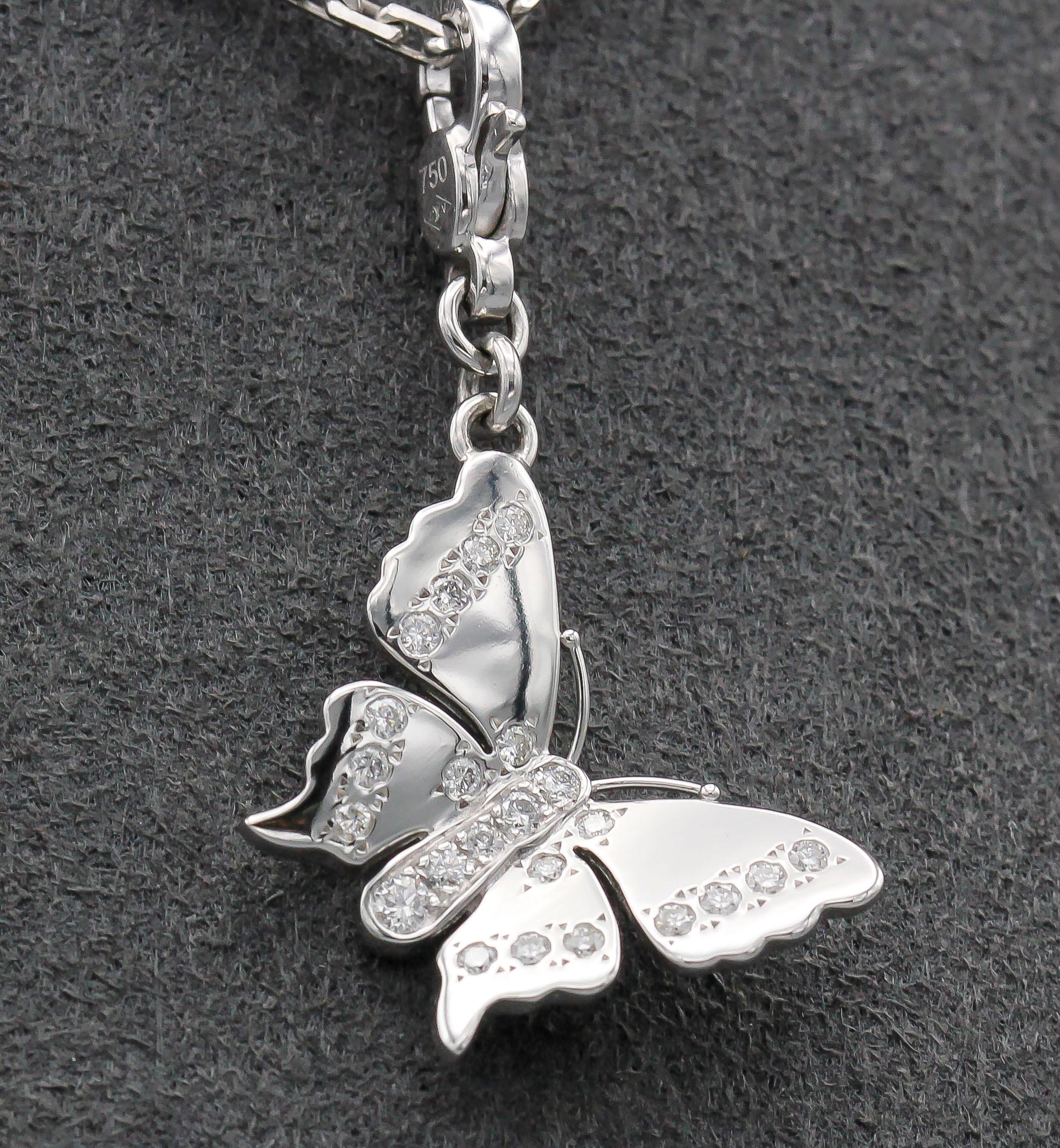Fine diamond and 18K white gold butterfly charm by Louis Vuitton. It features higrade diamonds on the body and wings of the butterfly.  Well made and easy to add to any bracelet or pendant.

Hallmarks: LV, 750 reference numbers, maker's mark