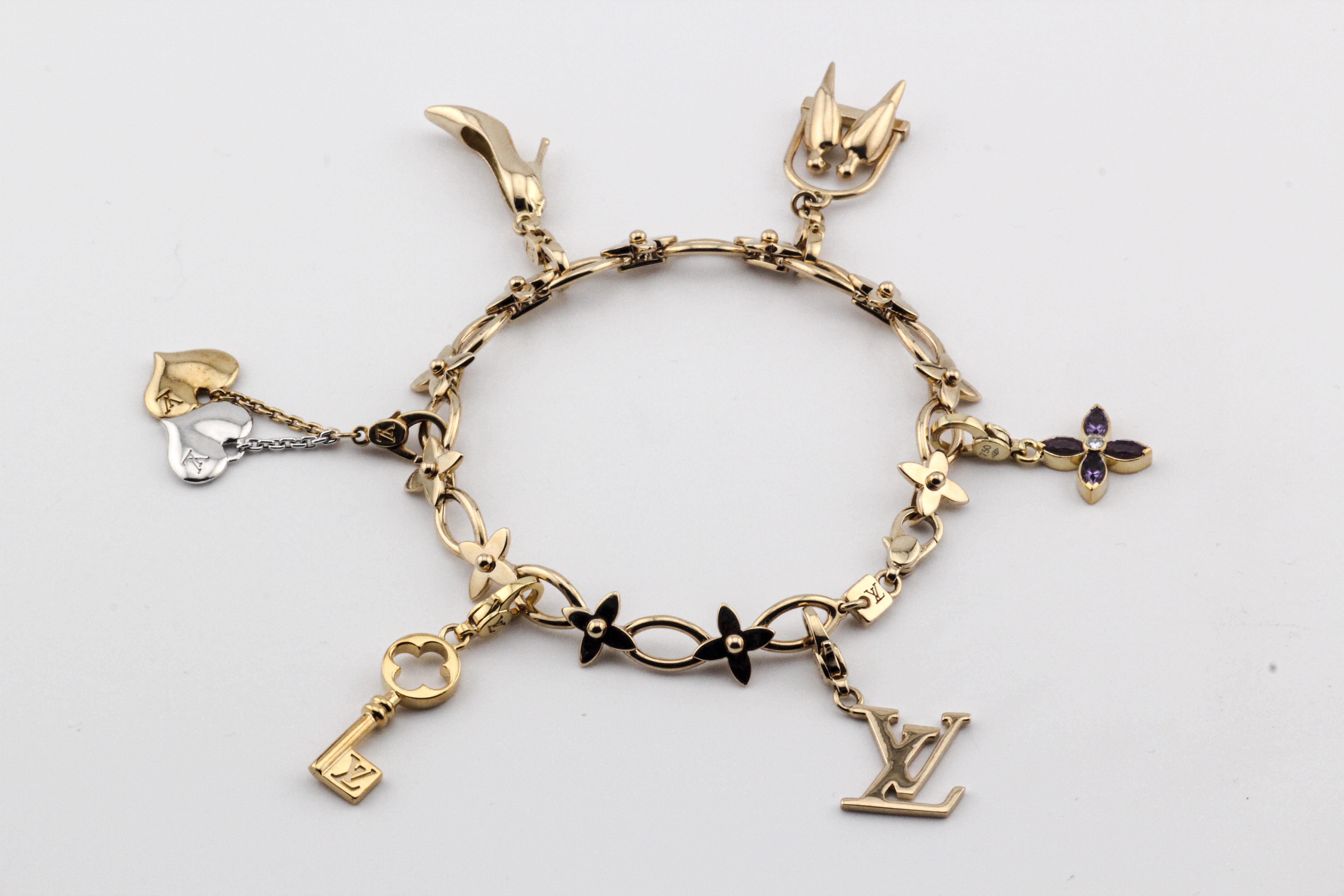 The Louis Vuitton 18K Gold 6 Charms Bracelet is a dazzling testament to the brand's signature blend of luxury and creativity. Crafted from the finest 18K gold, this exquisite bracelet features an array of charming motifs that add a whimsical touch