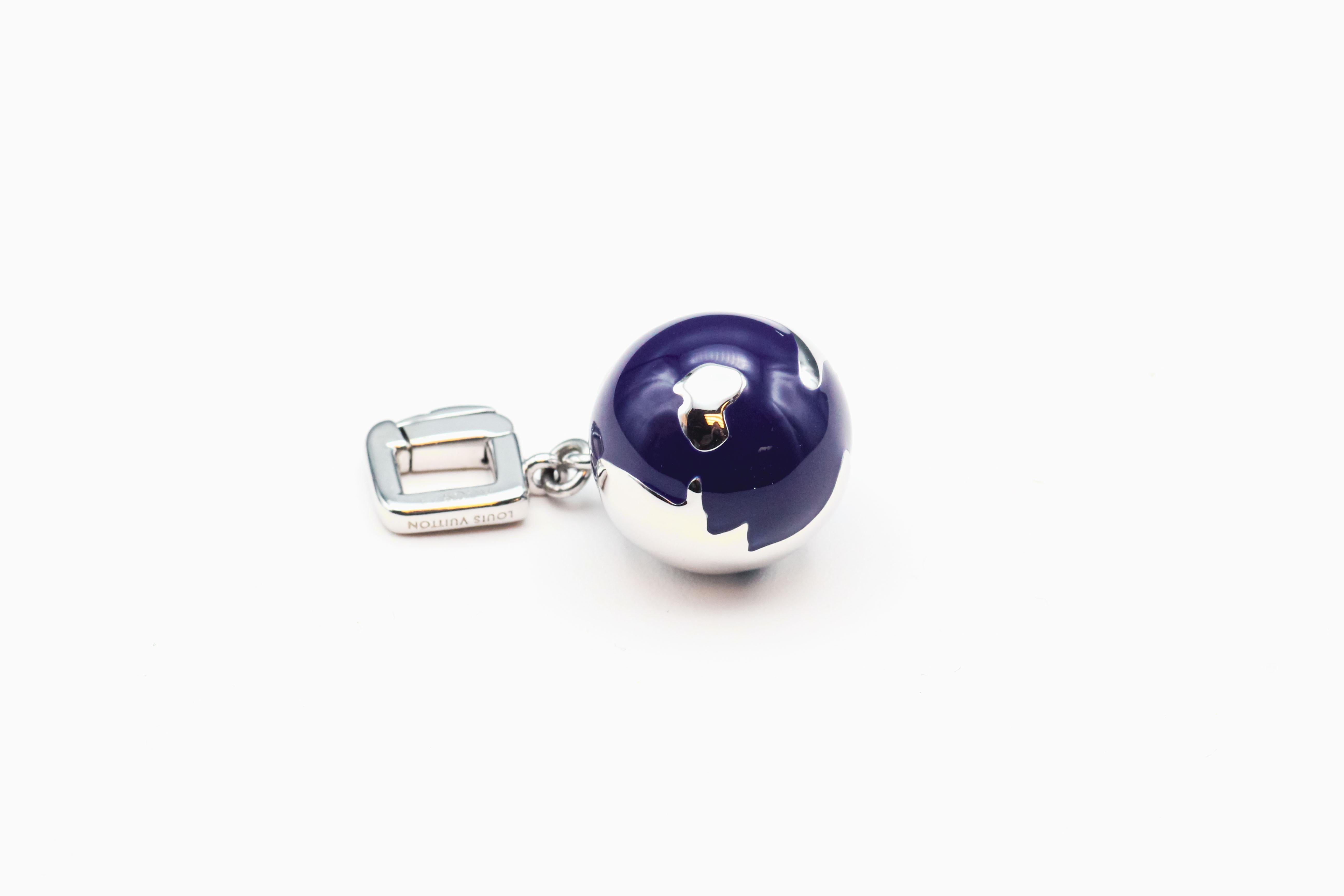 Embark on a journey of elegance and refinement with this Louis Vuitton diamond and enamel 18k white gold globe charm pendant. This exquisite piece seamlessly marries modern luxury with the timeless allure of world exploration, showcasing Louis
