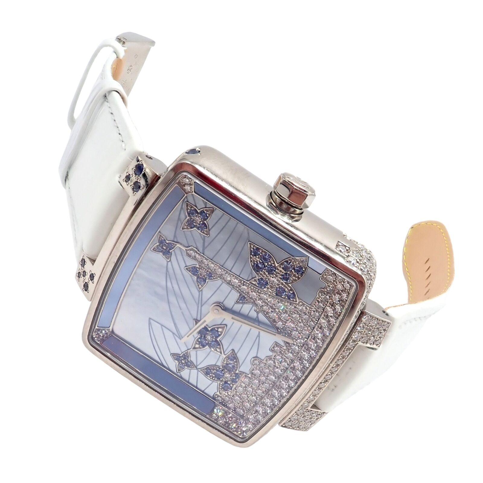 18k White Gold Diamond Sapphire Paris 34mm Ladies Watch Q233E Wristwatch by Louis Vuitton.
This is a luxurious limited edition Louis Vuitton ladies' watch crafted in 18K white gold. It boasts a unique Paris-themed design on its dial, adorned with
