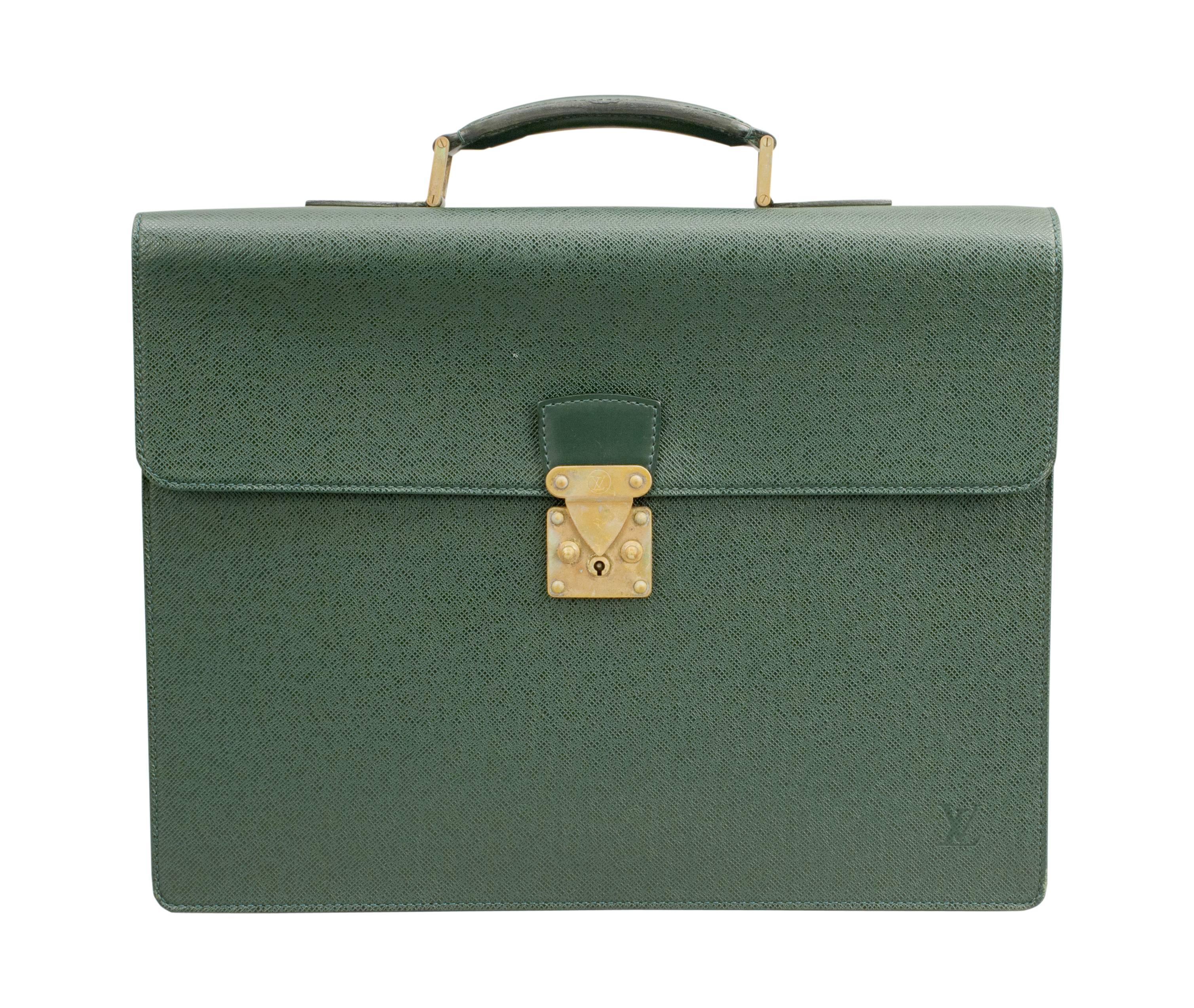 Louis Vuitton document case.
An original stylish Louis Vuitton monogrammed expandable briefcase. The case is made in green leather and features a sturdy reinforced leather top handle, frontal flap with brass press lock closure. The lock with