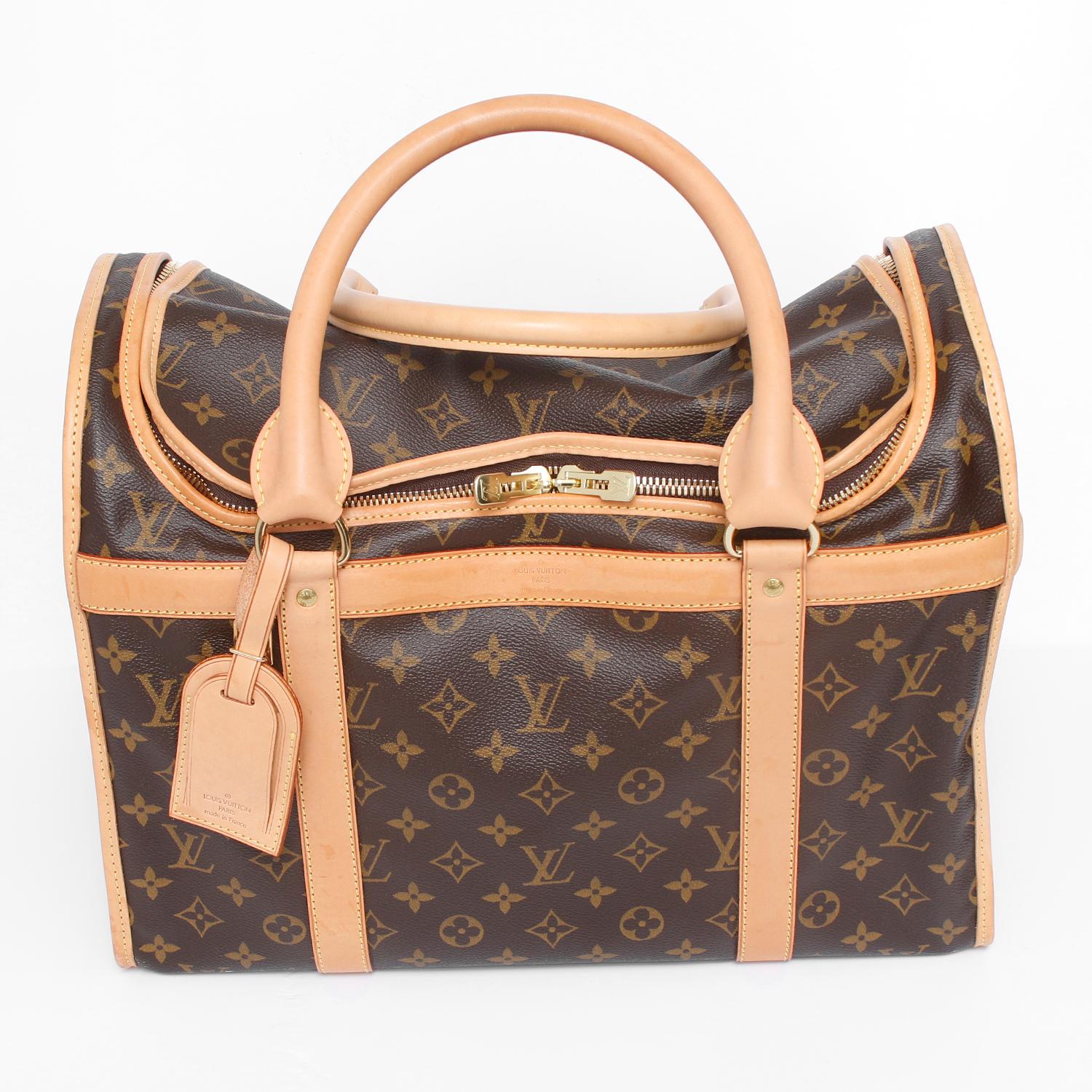 Louis Vuitton Dog Carrier 40  - This carrier in Monogram canvas is adapted to small dogs and particularly resistant to water and scratches. It is equipped with a breathable mesh window and zip-around closure. CURRENT RETAIL $2690

11.8 x 8.7 inches