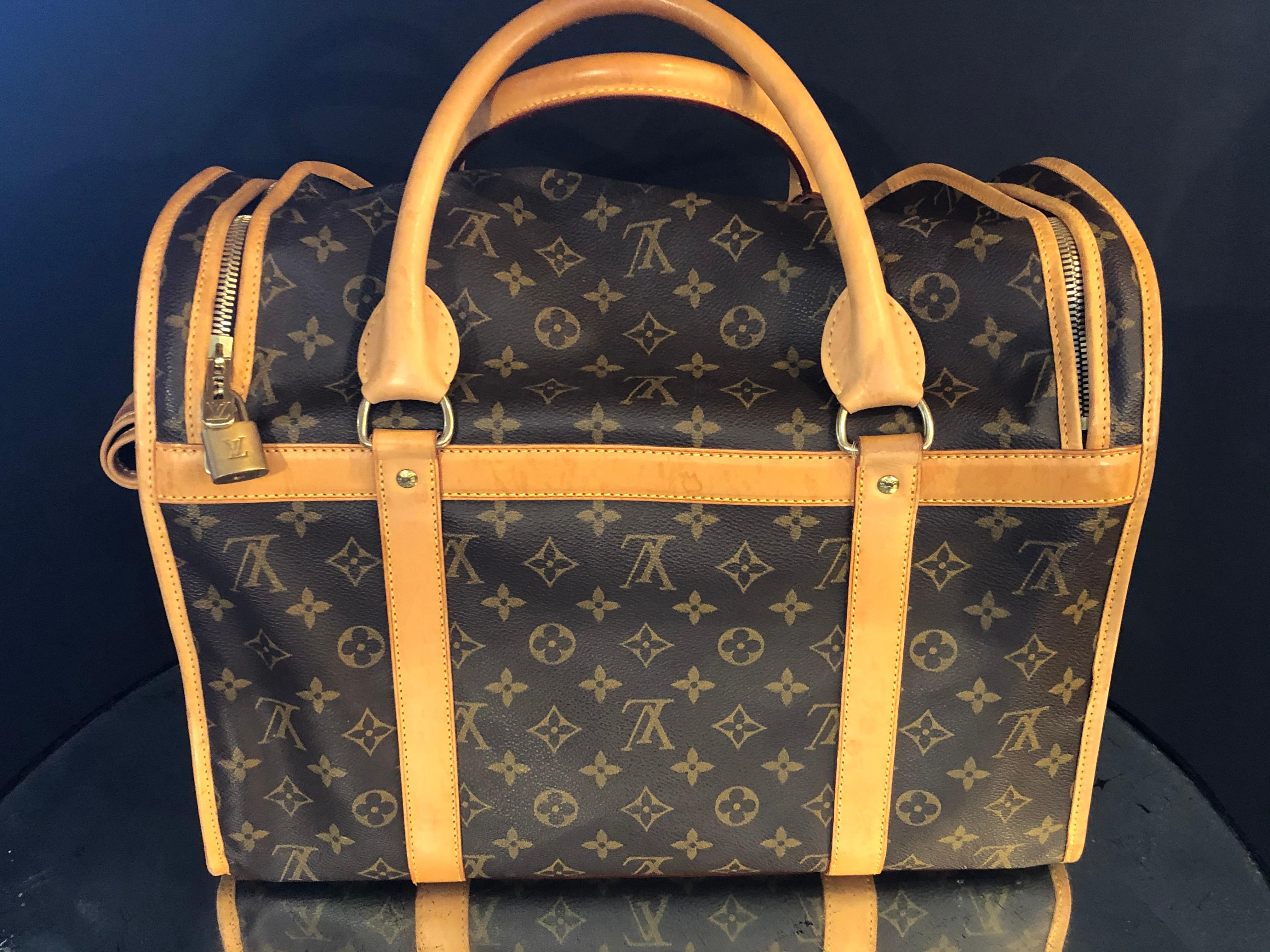 Louis Vuitton dog carrier 40 monogram canvas bag or luggage. This beautiful fine conditioned bag by Louis Vuitton has been used three times according to its prior owner. The bag is equipped with a breathable mesh window. Any dog would look classy