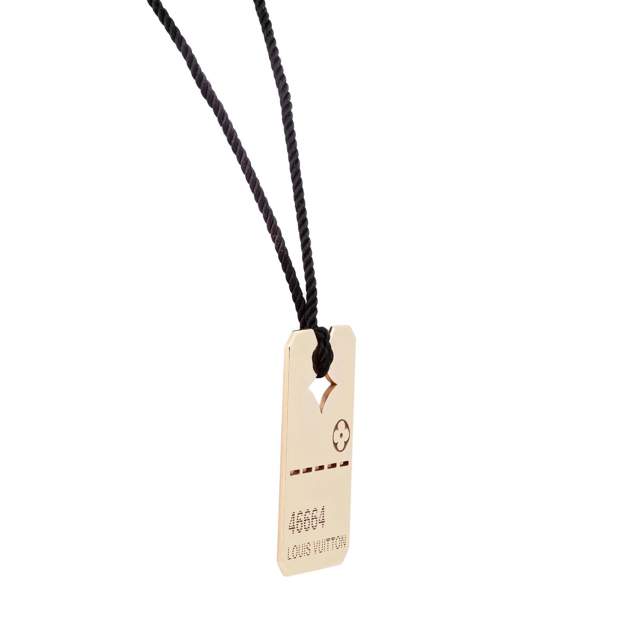 Bold and luxurious dog tag style pendant necklace from Louis Vuitton. Crafted in lustrous 18K yellow gold with rope thread. This piece is both cute and rebellious, with the popular floral icon, 46664 number and a prominent 