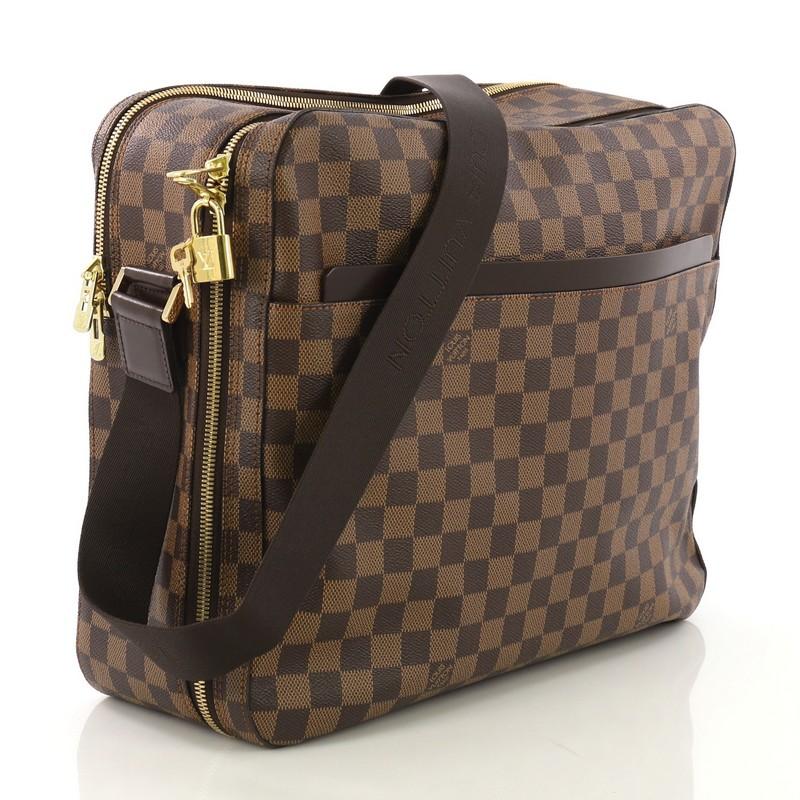 This Louis Vuitton Dorsoduro Messenger Bag Damier, crafted from damier ebene coated canvas, features adjustable shoulder strap, two exterior pockets, leather trim, and gold-tone hardware. Its two-way zip closures on both compartments open to a brown