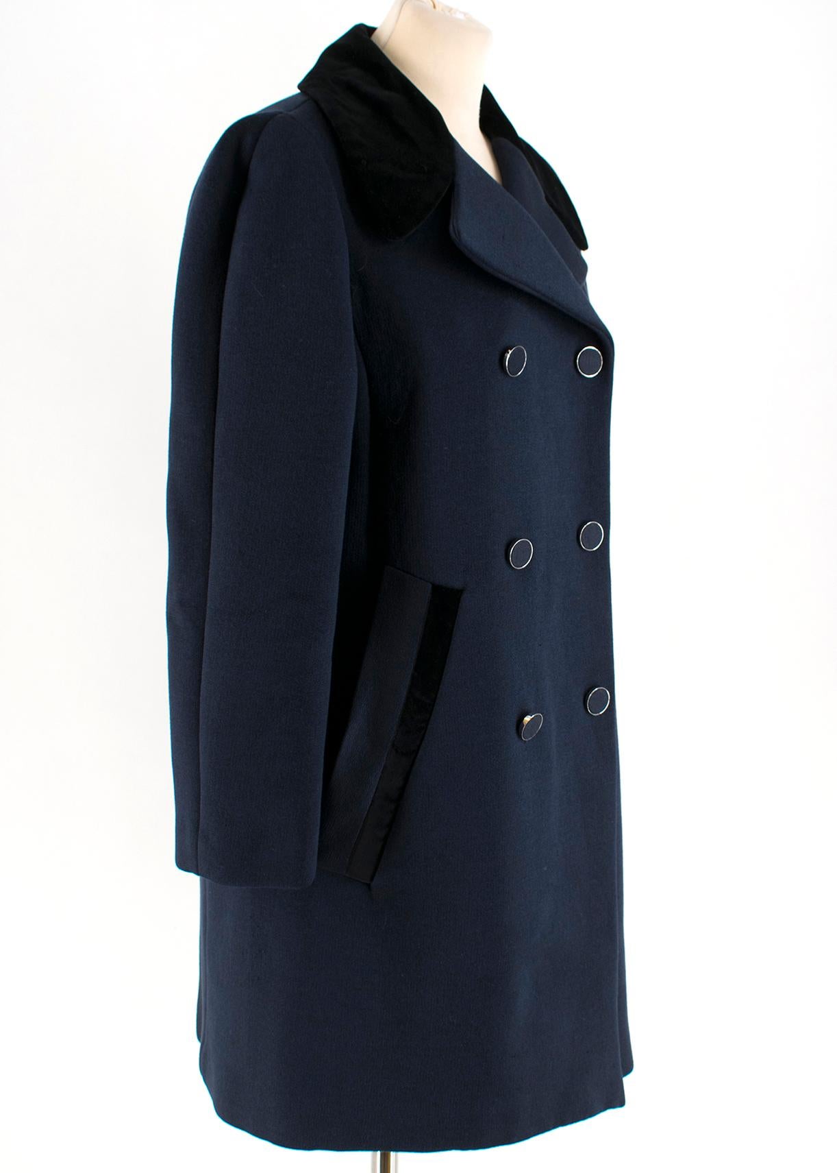 Louis Vuitton Double breasted Navy Coat 

Double breasted coat
Two tone detailing 
Black velvet collar 
Velvet pocket detailing 
Form fitting 
Silver hardware
Silver and blue button closure 
Snap Closure 
Lapel Collar
Two exterior slip