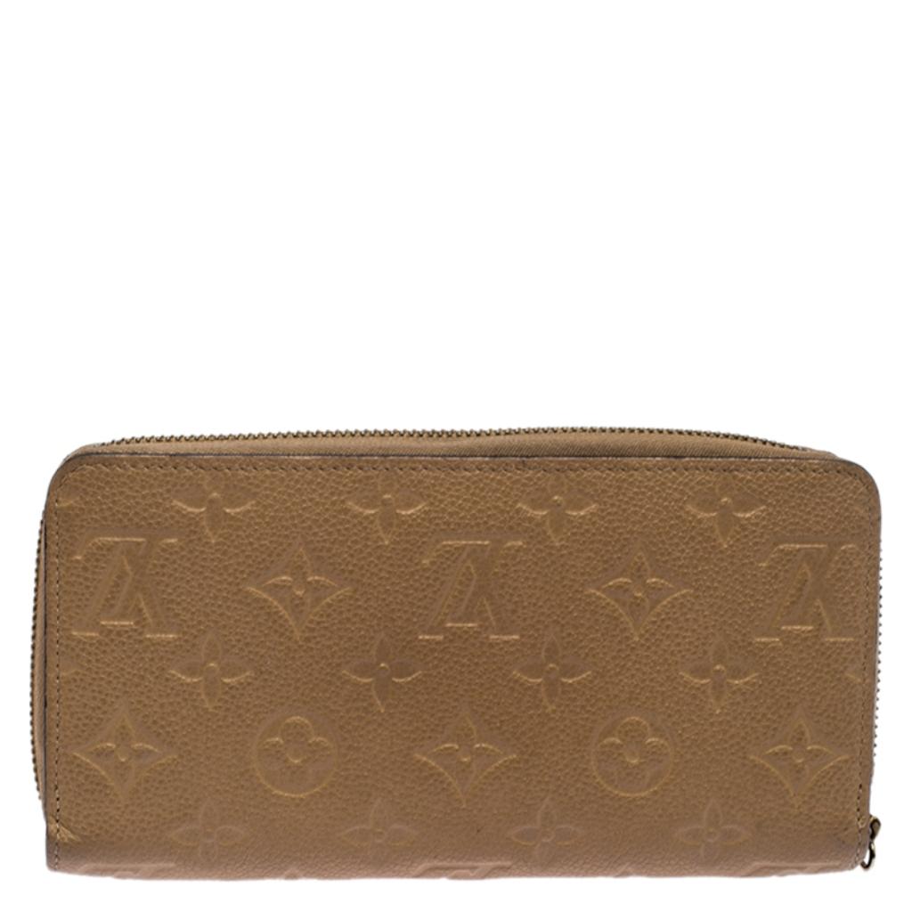 This Louis Vuitton Zippy wallet is conveniently designed for everyday use. Crafted from beige Monogram Empreinte leather, the wallet has a wide zip closure which opens to reveal multiple slots, Leather-lined compartments and a zip pocket for you to
