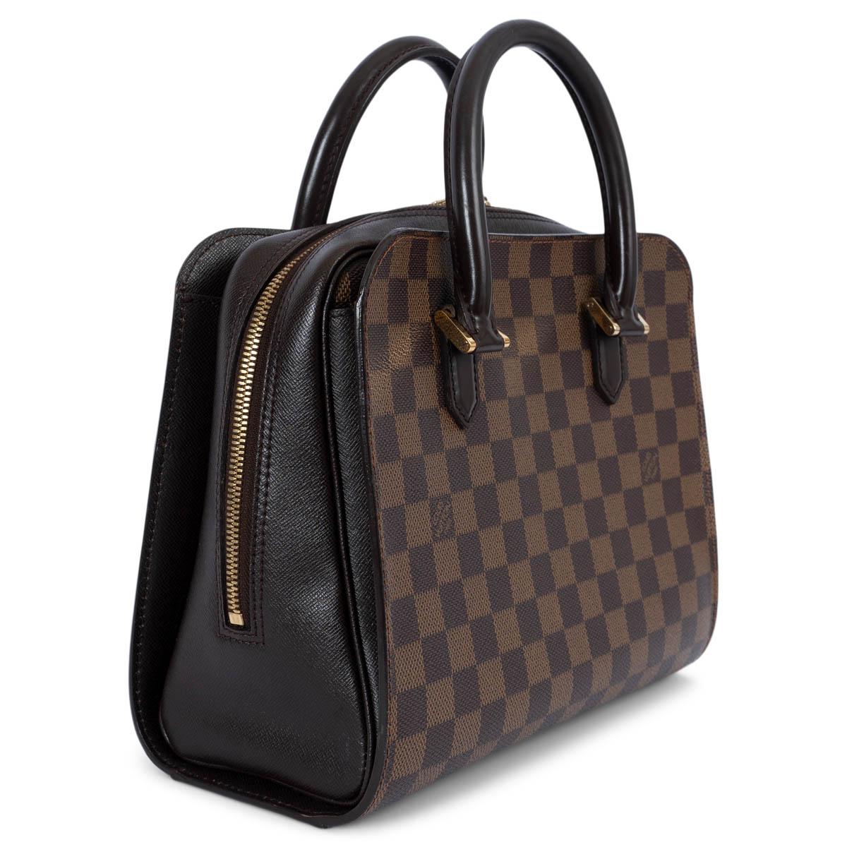 100% authentic Louis Vuitton Triana bag in Ebene brown classic Damier canvas. The design features two rolled top handles, a two-way zip fastening, gold-tone hardware and two big outside pockets. Lined in orange alcantara with one zip pocket against