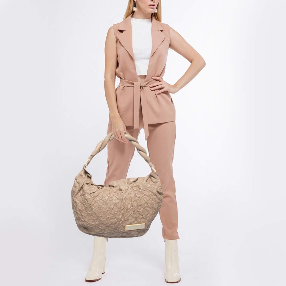 Brimming with elegance and beauty, this Louis Vuitton bag will instantly amp up your ensemble. Made using the best materials, this authentic LV Limited Edition Olympe Nimbus GM is a perfect ode to the House's meticulous craftsmanship.

