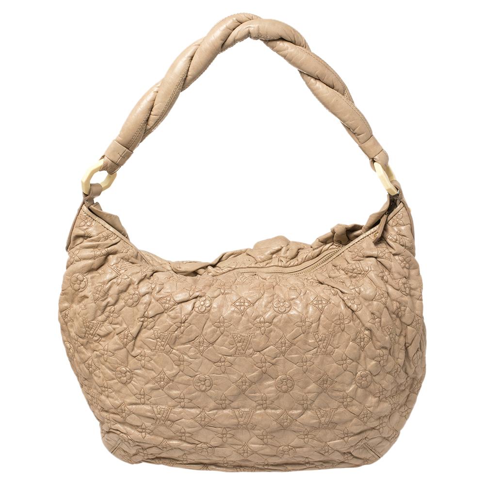 This hard-to-find Limited Edition Olympe Nimbus bag is a design marvel. Flawlessly crafted from Monogram leather, it features a slouchy, chic look and a twisted handle. The bag is named after Mount Olympus and the intricate design is meant to