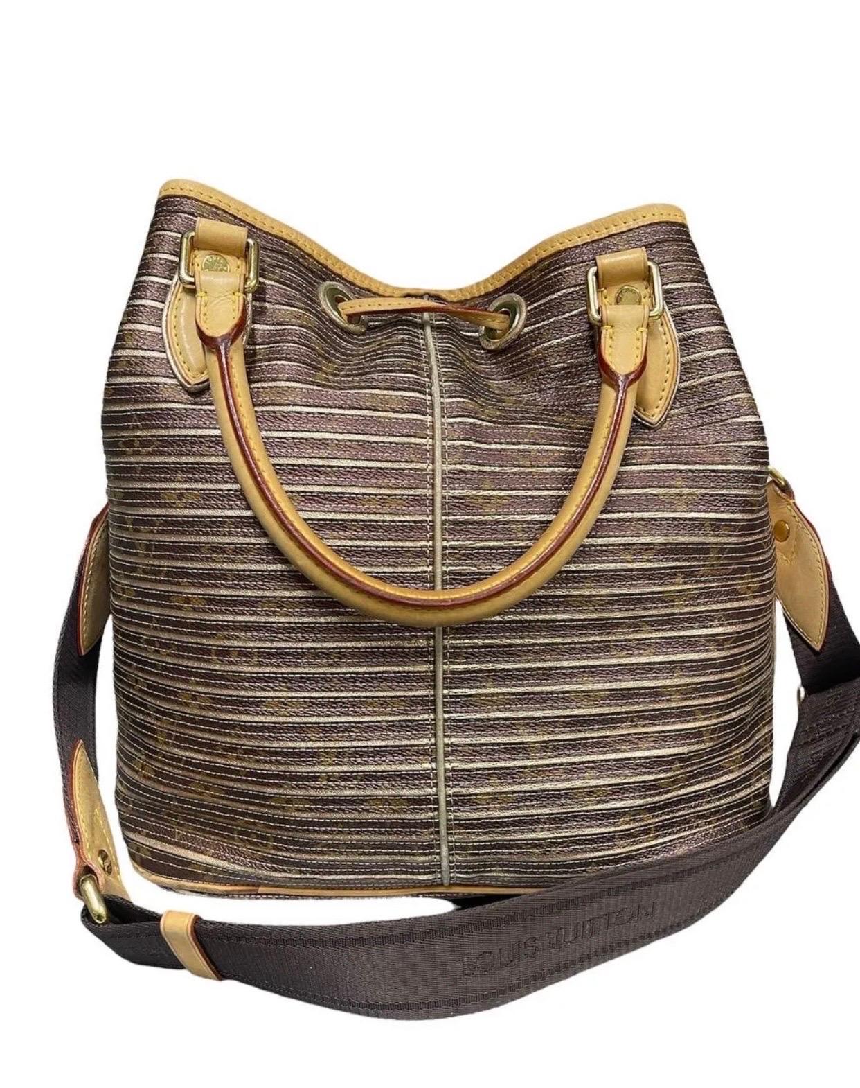 The Eden Neo Peche Monogram bag by Louis Vuitton is a unique and practical bag. The bag features a superimposition of Monogram metallic stripes. It has a drawstring closure in leather, upper handles and a canvas shoulder strap. You can carry this