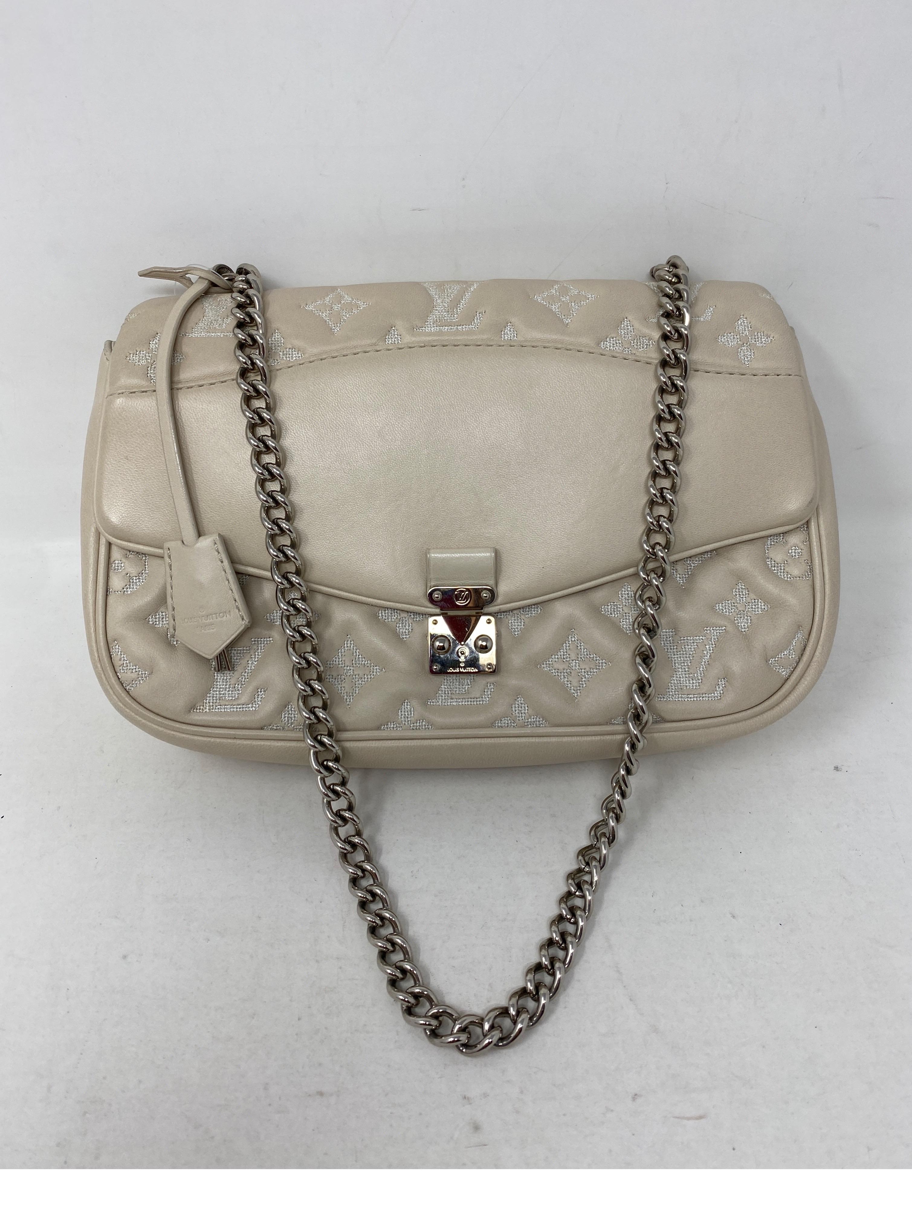 Louis Vuitton White Eimpreinte Leather Bag. Silver hardware. Good condition. Can be worn as a clutch or a shoulder bag. Guaranteed authentic. 