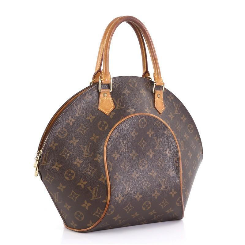 This Louis Vuitton Ellipse Bag Monogram Canvas MM, crafted from brown monogram coated canvas, features natural cowhide leather trim, dual rolled handles, and gold-tone hardware. Its two-way zip closure opens to a brown fabric interior with slip
