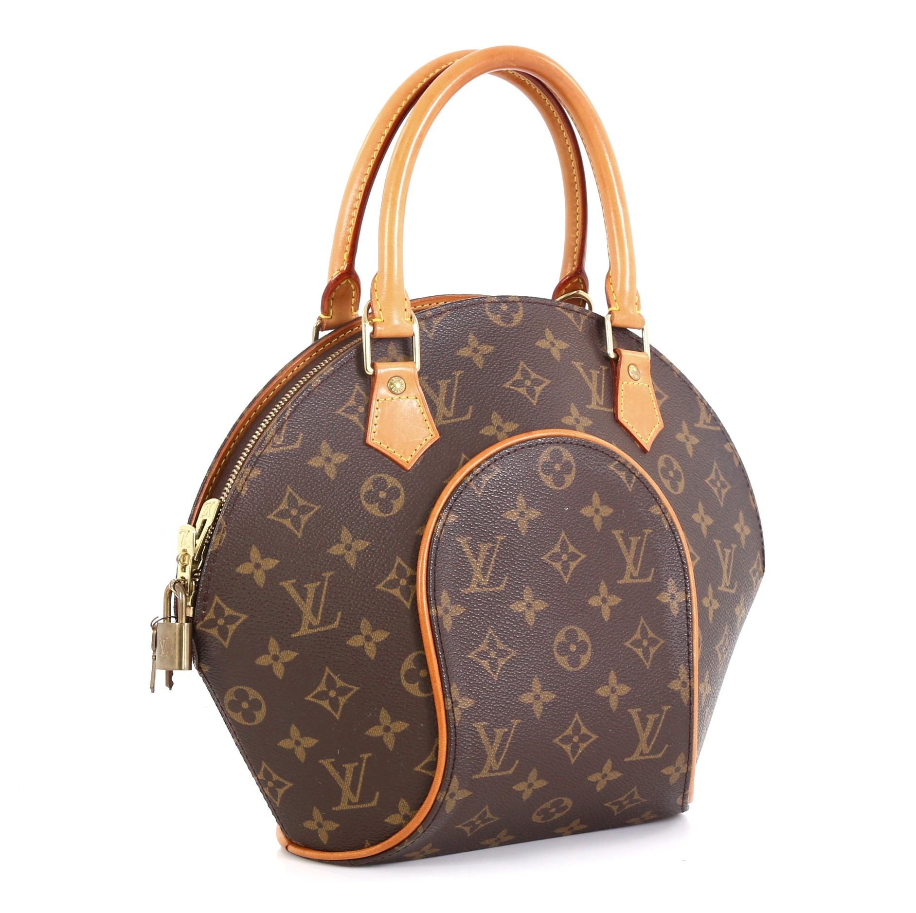 This Louis Vuitton Ellipse Bag Monogram Canvas PM, crafted from brown monogram coated canvas, features natural cowhide leather pipings, dual rolled handles, and gold-tone hardware. Its zip closure opens to a brown fabric interior with side slip