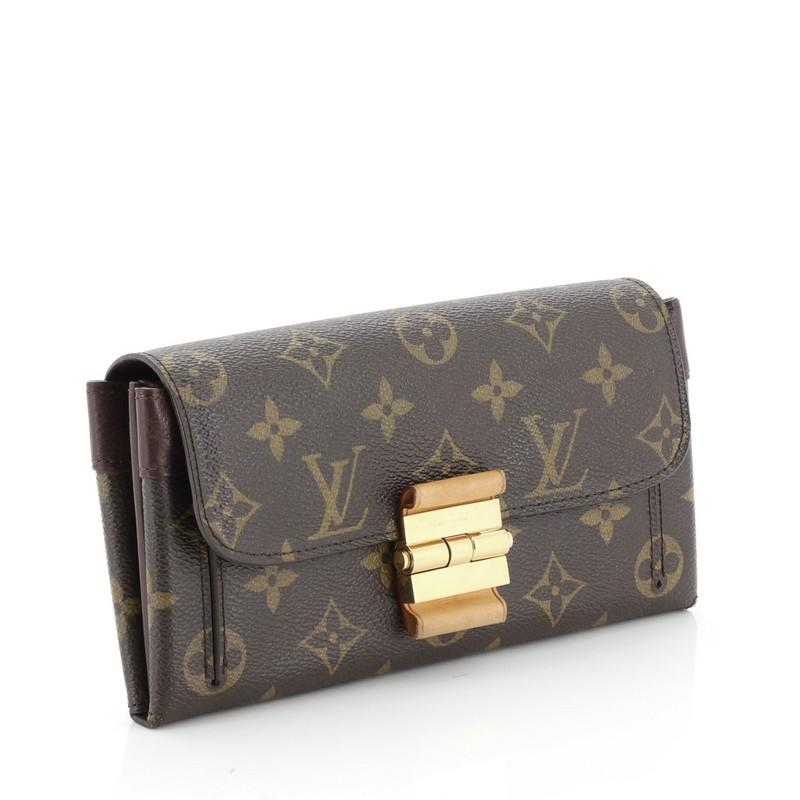 ThisLouis Vuitton Elysee Wallet Monogram Canvas and Leather, crafted in brown monogram coated canvas and leather, features slip pocket under flap and gold-tone hardware. Its flap opens to a brown monogram coated canvas and red leather interior with