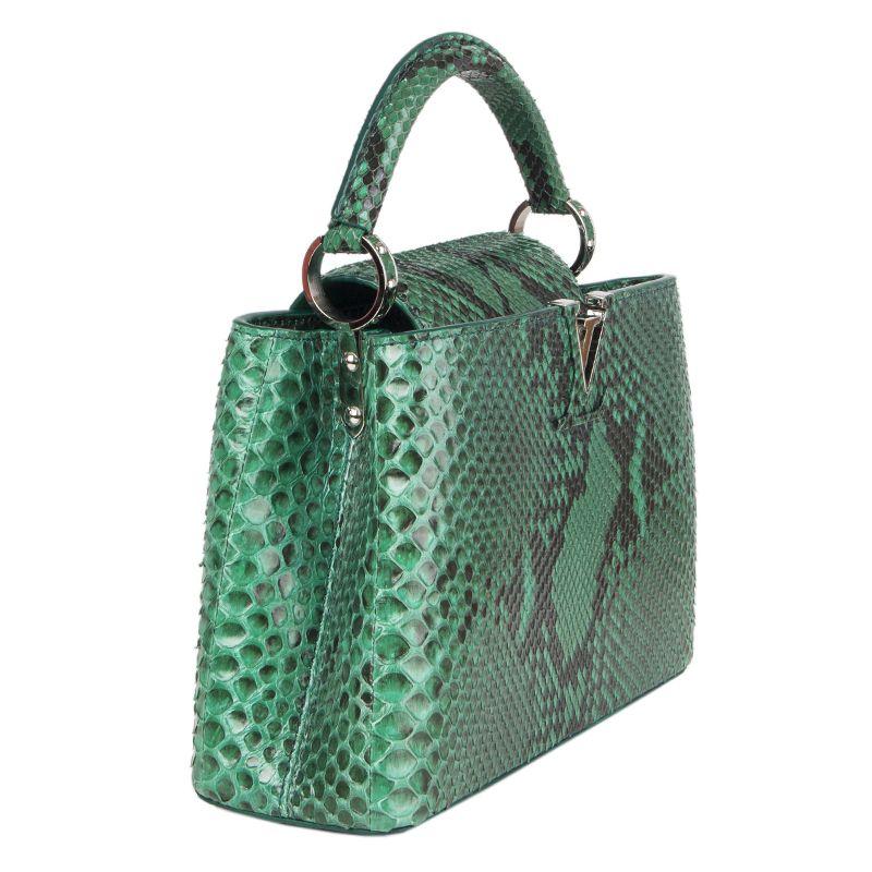 Louis Vuitton 'Capucines BB' shoulder bag in Emeraud (emerald green) python. Detachable shoulder strap. Closes with a flap and dog-hook on top. Divided into two comparements. Lined in green leather with a zipper pocket against the back. Brand new.