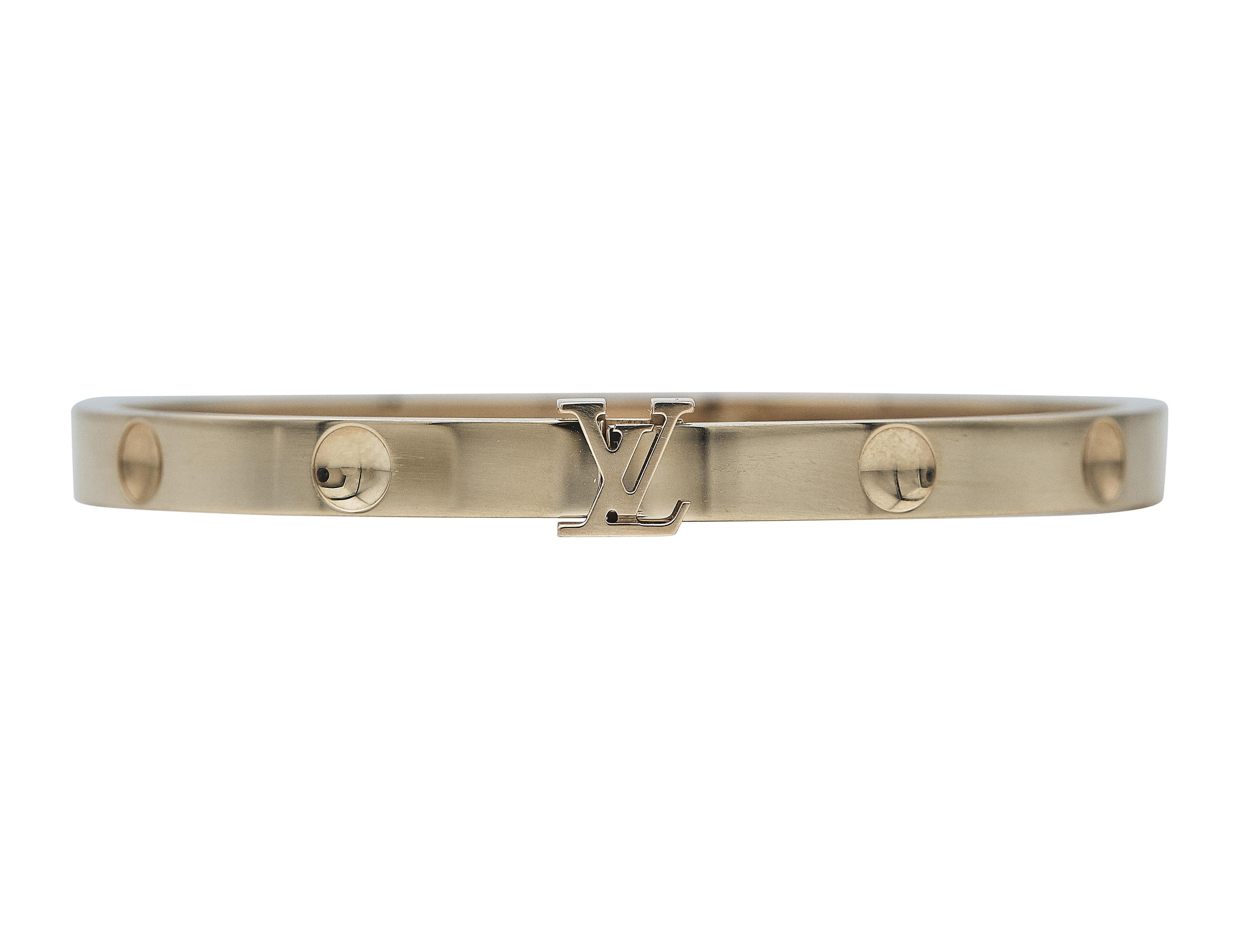 The bracelet:
A Louis Vuitton Empreinte bangle bracelet designed in eighteen karat rose gold. This hinged bangle bracelet, displaying the Louis Vuitton logo, is a size 16.

The bracelet is in good condition, with only a few minor scratches that are