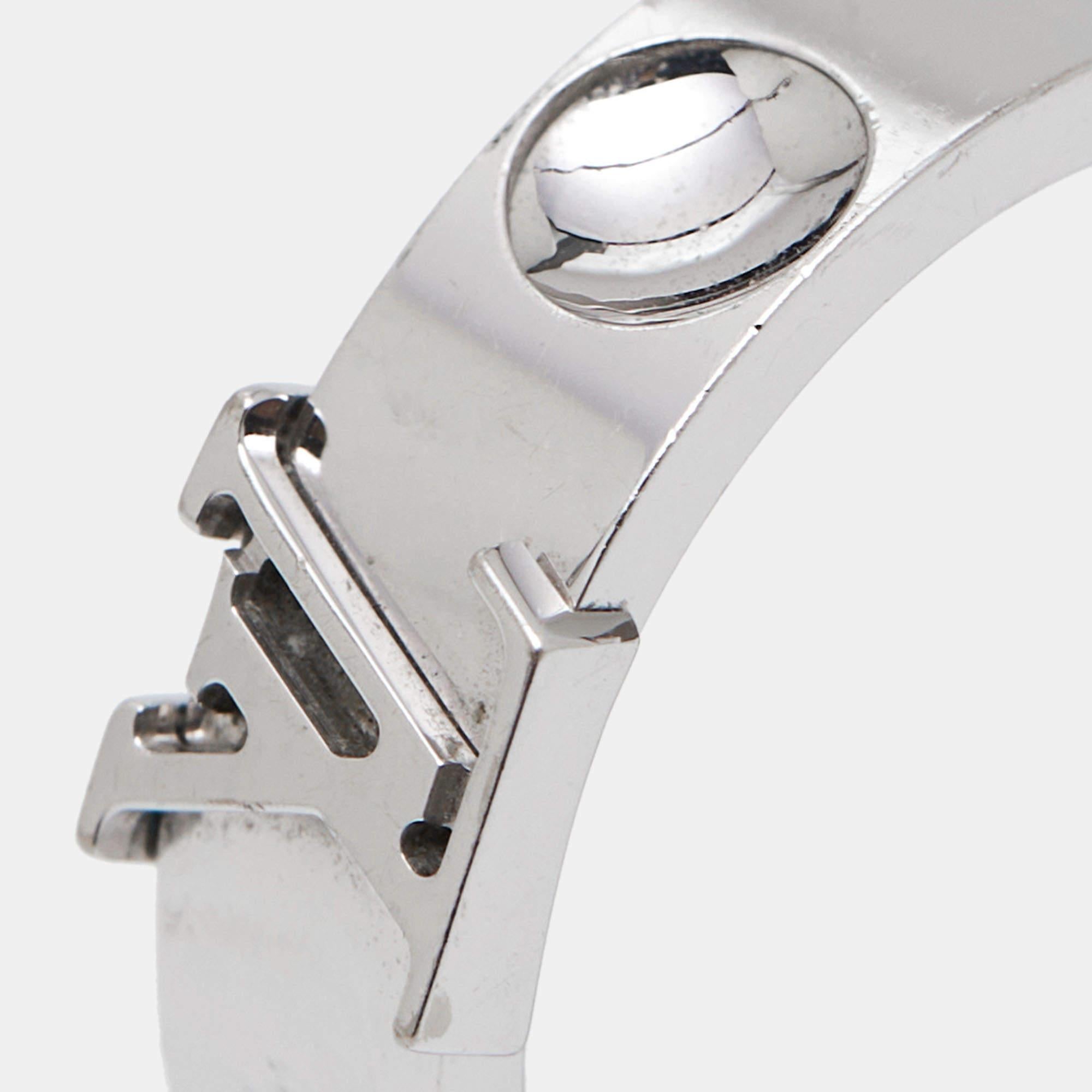 Crafted with precision and opulence, the Louis Vuitton ring exudes timeless elegance. Its delicate curves embrace a brilliant display of white gold, adorned with the iconic LV emblem meticulously placed. A symbol of refined luxury, it adds a touch