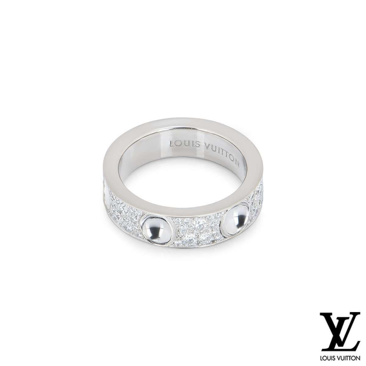 A stunning diamond set ring from the Empreinte collection by Louis Vuitton. The ring features 6 inverted stud motifs, one engraved with the Louis Vuitton logo. Set in-between each stud are pave set round brilliant cut diamonds totalling