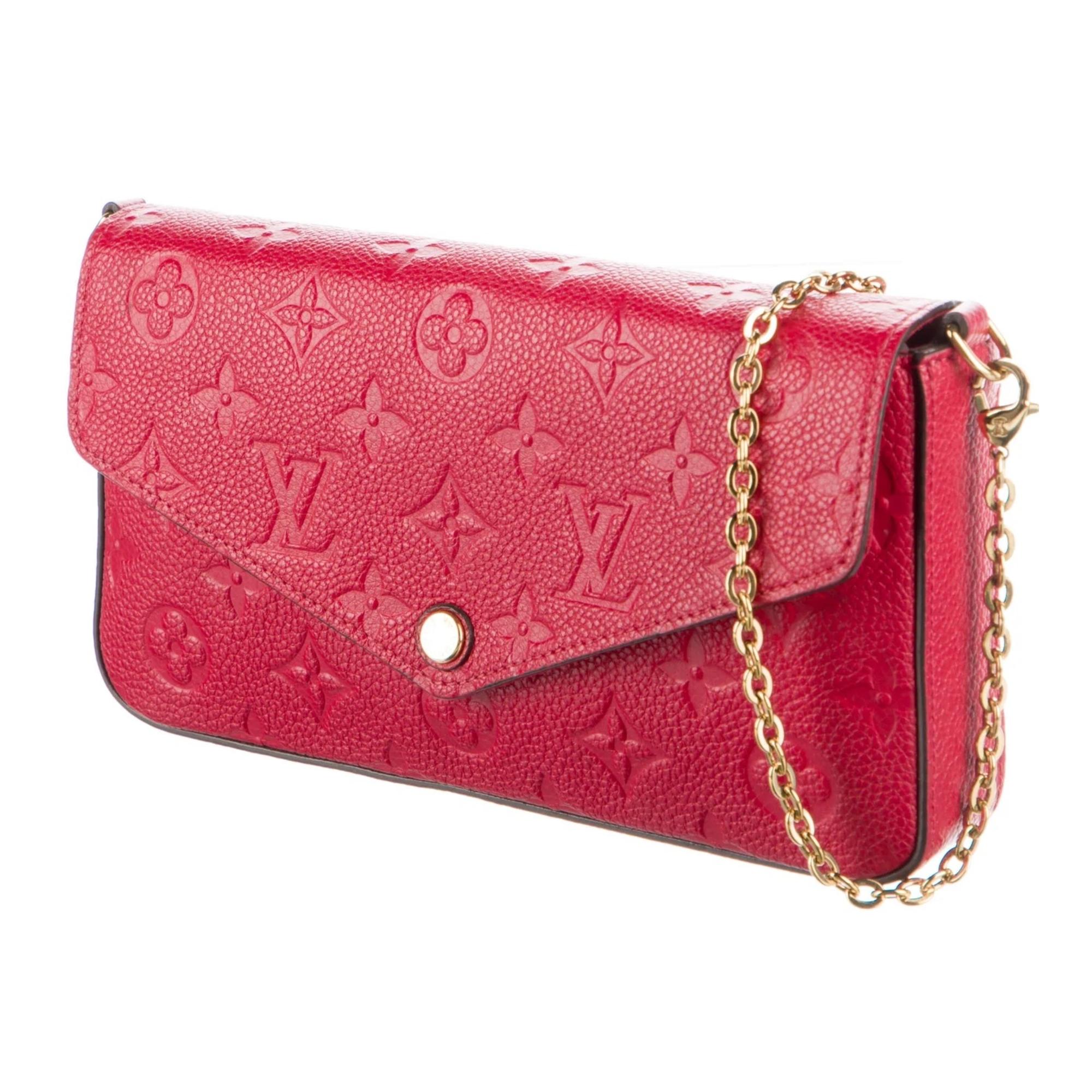 This pochette with a chain bag is constructed of Louis Vuitton monogrammed empreinte leather in red. Louis's empreinte leather is a supple grained cowhide with monogram embossing. The shoulder bag features an envelope style facing flap. This opens