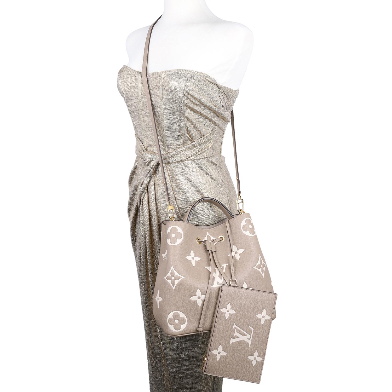 Authentic LIKE NEW NéoNoé dove cream shoulder cross body tote bag. Features Tourterelle dove cream embossed grained cowhide leather, grained cowhide-leather trim, microfiber interior lining, gold hardware, drawstring closure, and an interior wallet