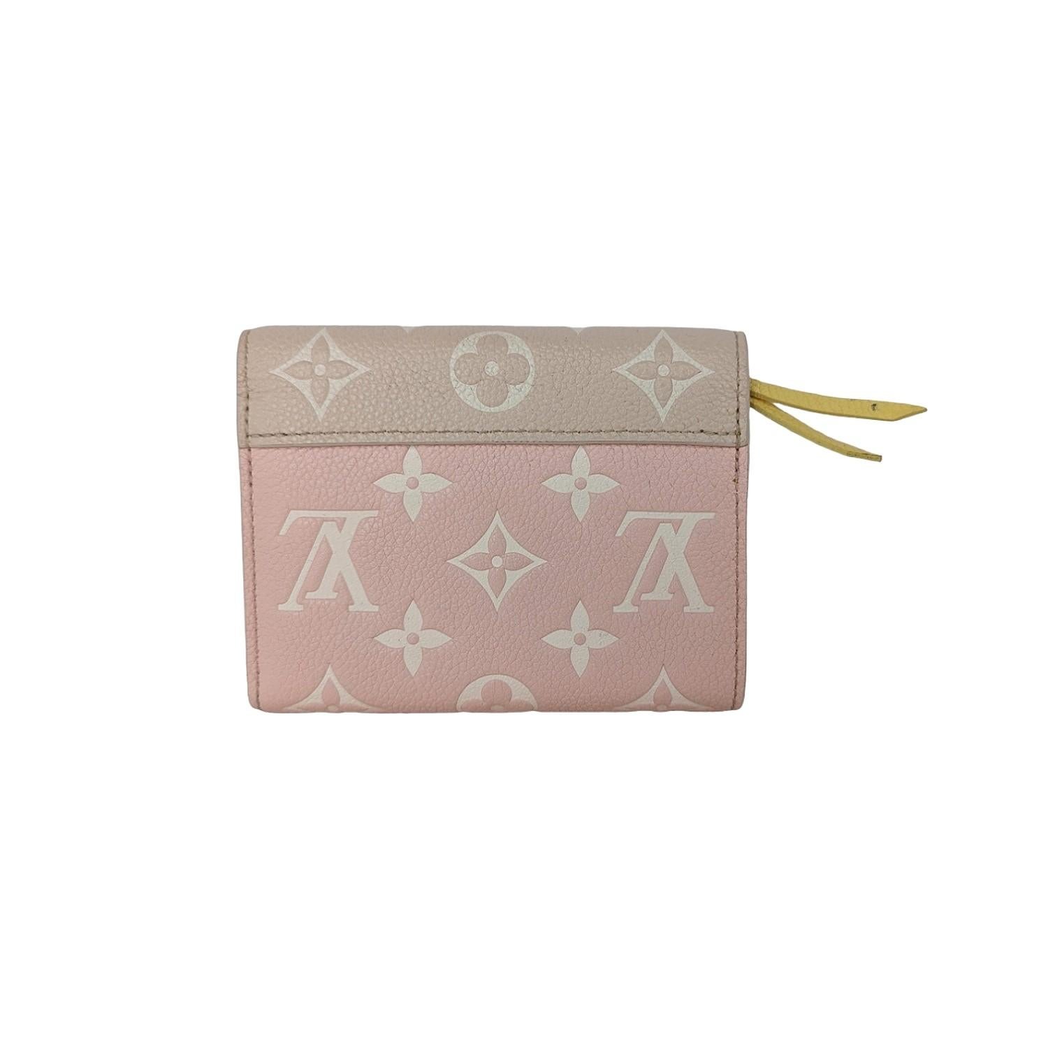 Louis Vuitton Empreinte Monogram Spring in the City Victorine Wallet in Pink, Beige and Yellow. This pre-owned luxury wallet is part of the Louis Vuitton Spring 2022 “Spring in the City” collection. This limited edition wallet is crafted of Louis