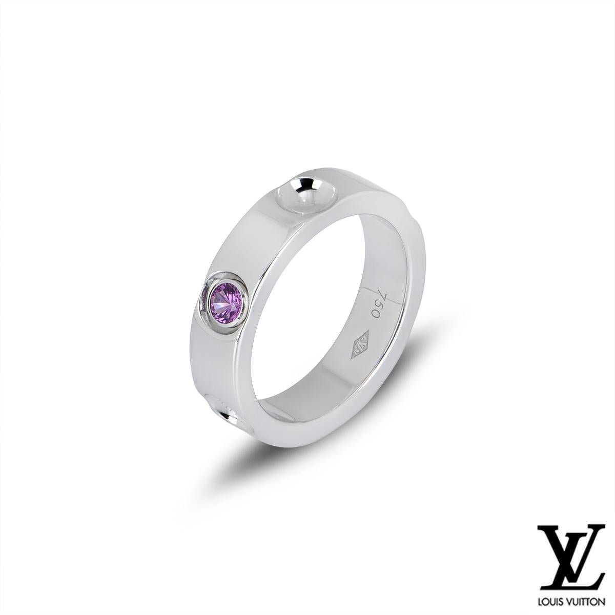 A stunning 18k white gold ring from the Empreinte collection by Louis Vuitton. The ring features 5 inverted stud motifs, one engraved with the Louis Vuitton logo. The ring is set with a single round cut pink sapphire, weighing approximately 0.10ct.